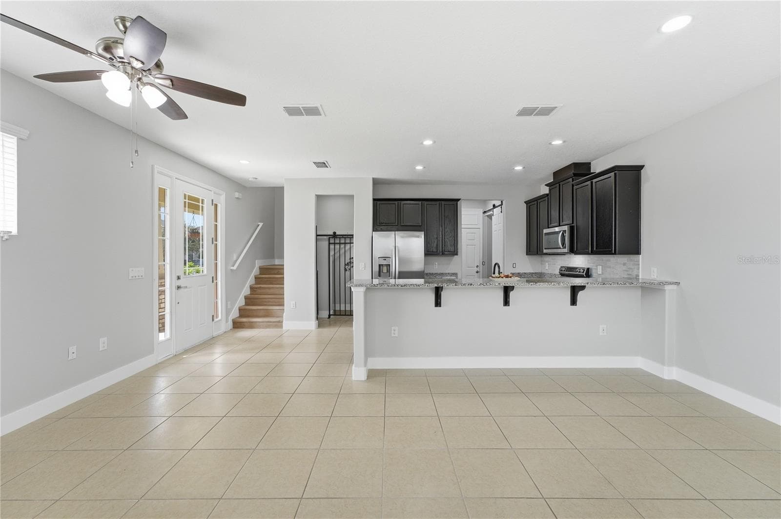 Expansive open-concept living and dining area flows seamlessly into the kitchen—ideal for entertaining. - 2615 GIARDINO LOOP, KISSIMMEE