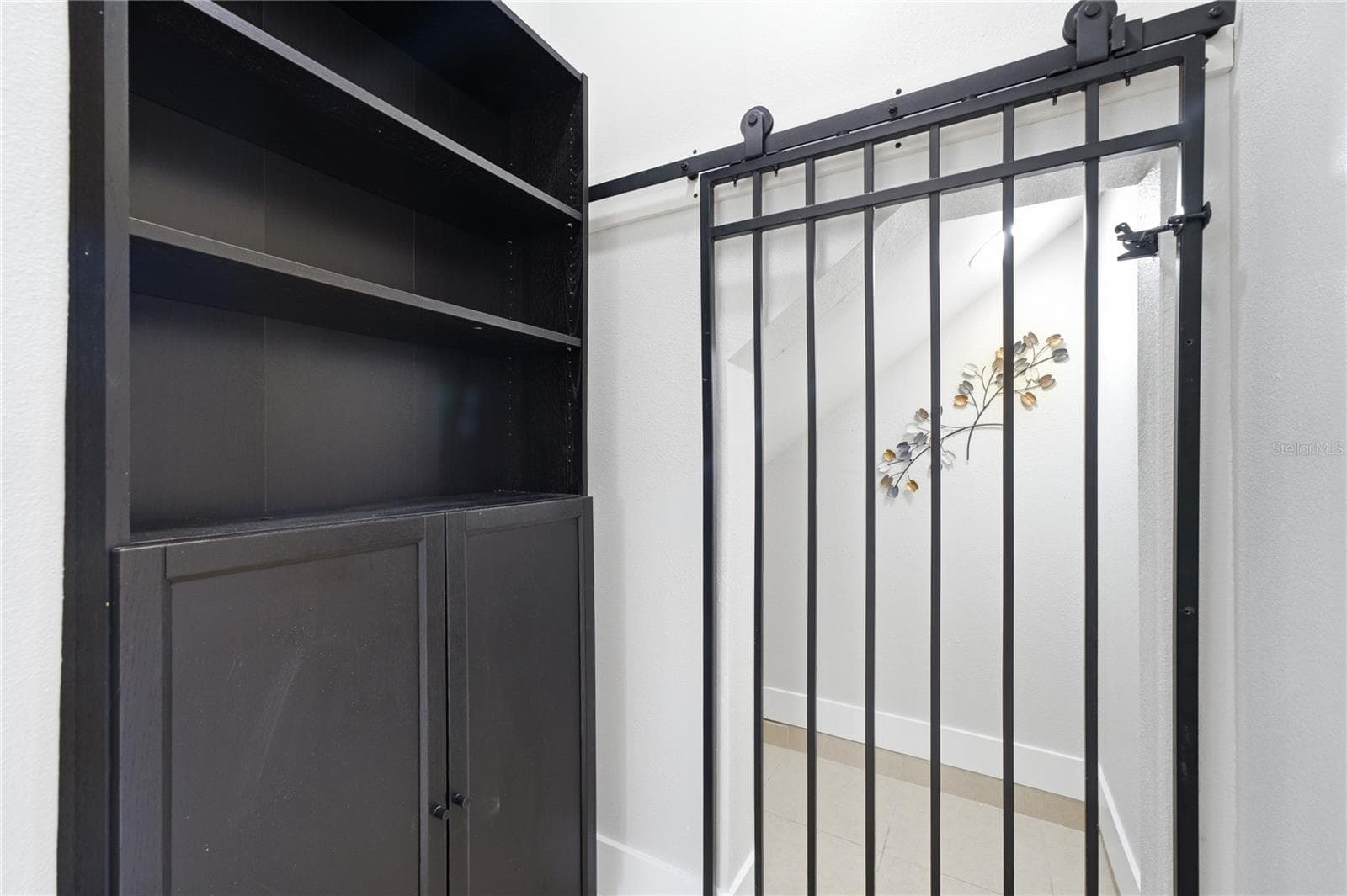 Unique under-stair space with a sliding iron gate—ideal for a custom wine cellar, bar or coffee station. - 2615 GIARDINO LOOP, KISSIMMEE