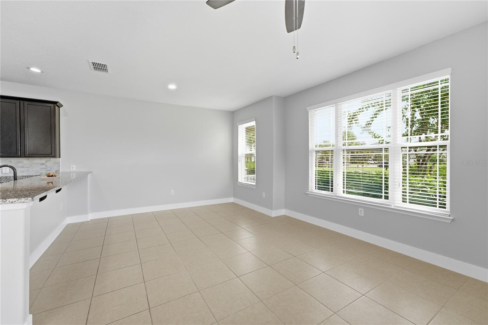 Bright and spacious living and dining area with abundant natural light. - 2615 GIARDINO LOOP, KISSIMMEE