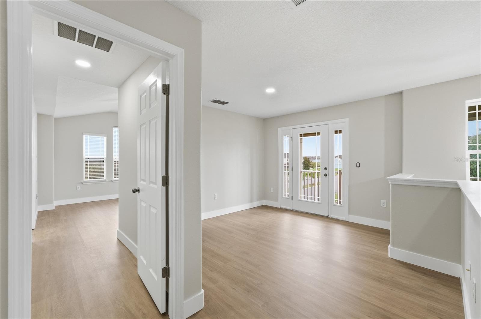 Loft with balcony access and the private primary suite entrance to the left. - 2615 GIARDINO LOOP, KISSIMMEE