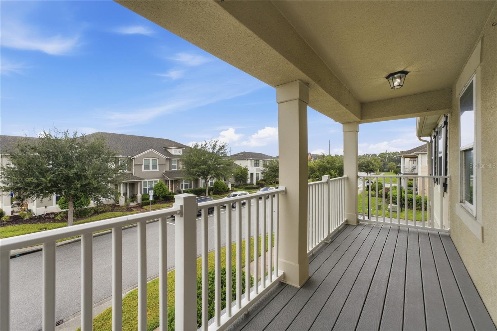 Another view of the spacious covered second-floor balcony—an inviting spot to relax and enjoy the neighborhood scenery. - 2615 GIARDINO LOOP, KISSIMMEE