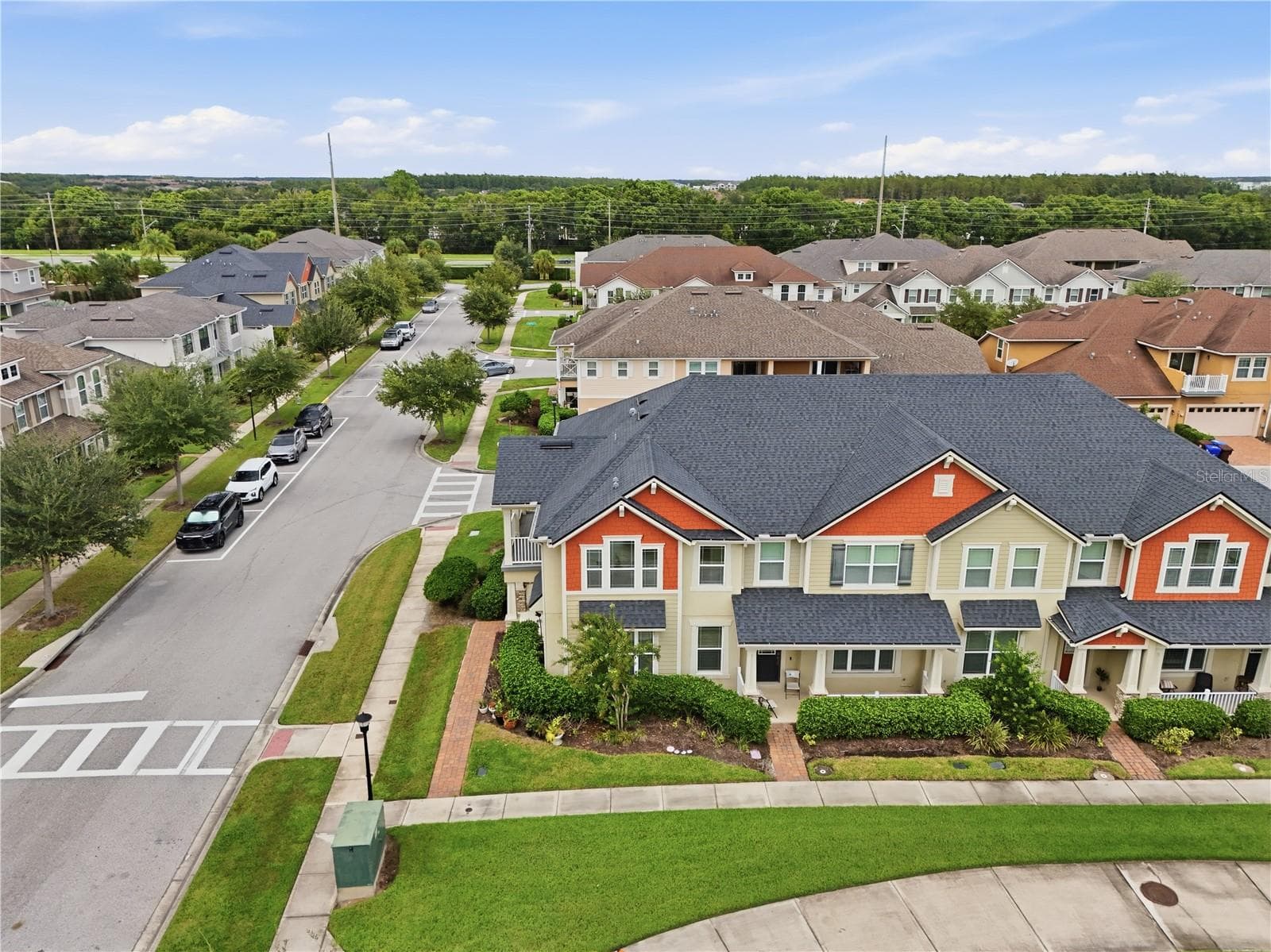 Aerial view highlighting the townhome’s desirable end-unit location and additional surrounding green space. - 2615 GIARDINO LOOP, KISSIMMEE