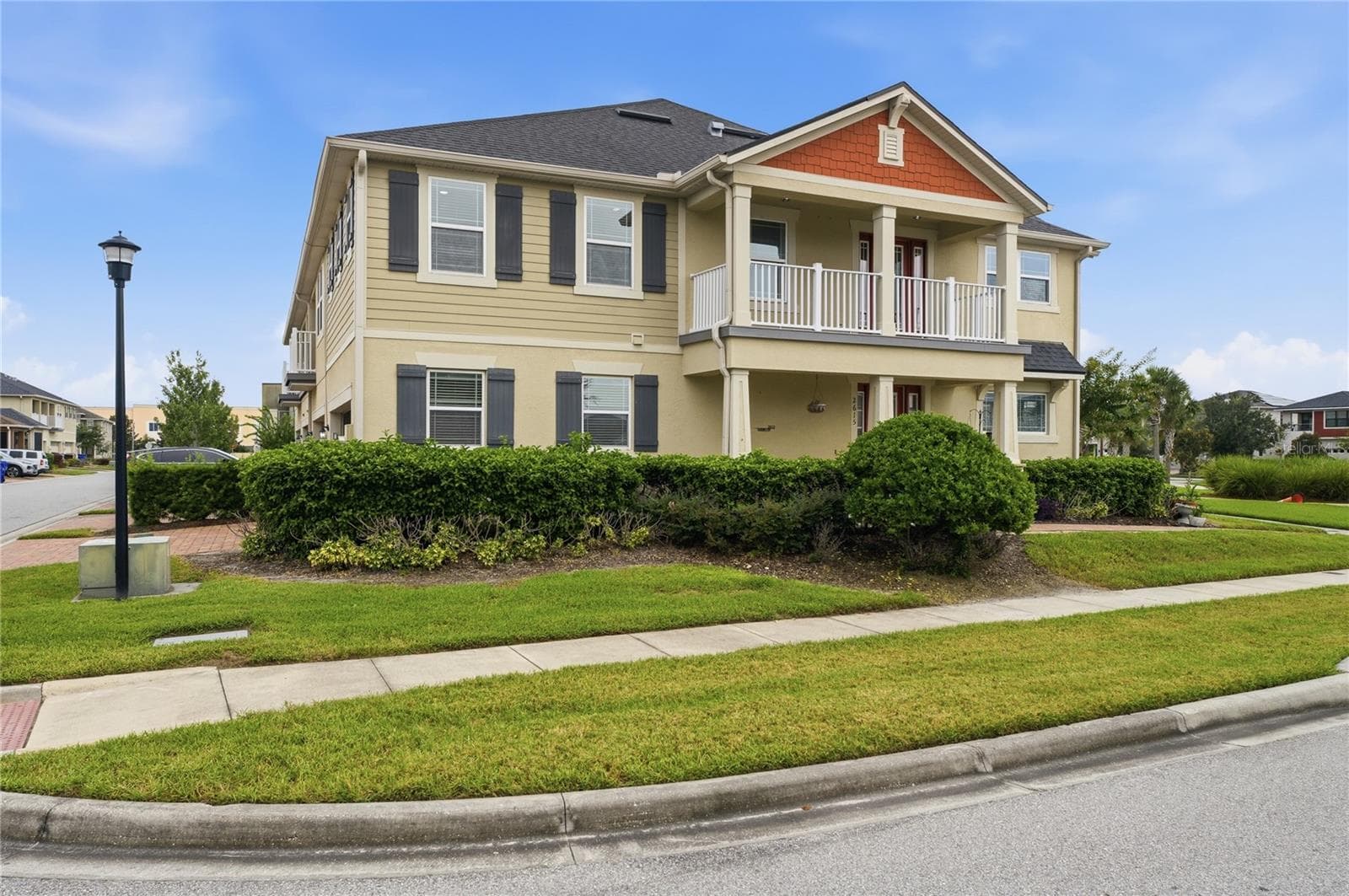Beautiful end-unit exterior with additional windows, side green space, a covered porch and second-floor balcony. - 2615 GIARDINO LOOP, KISSIMMEE