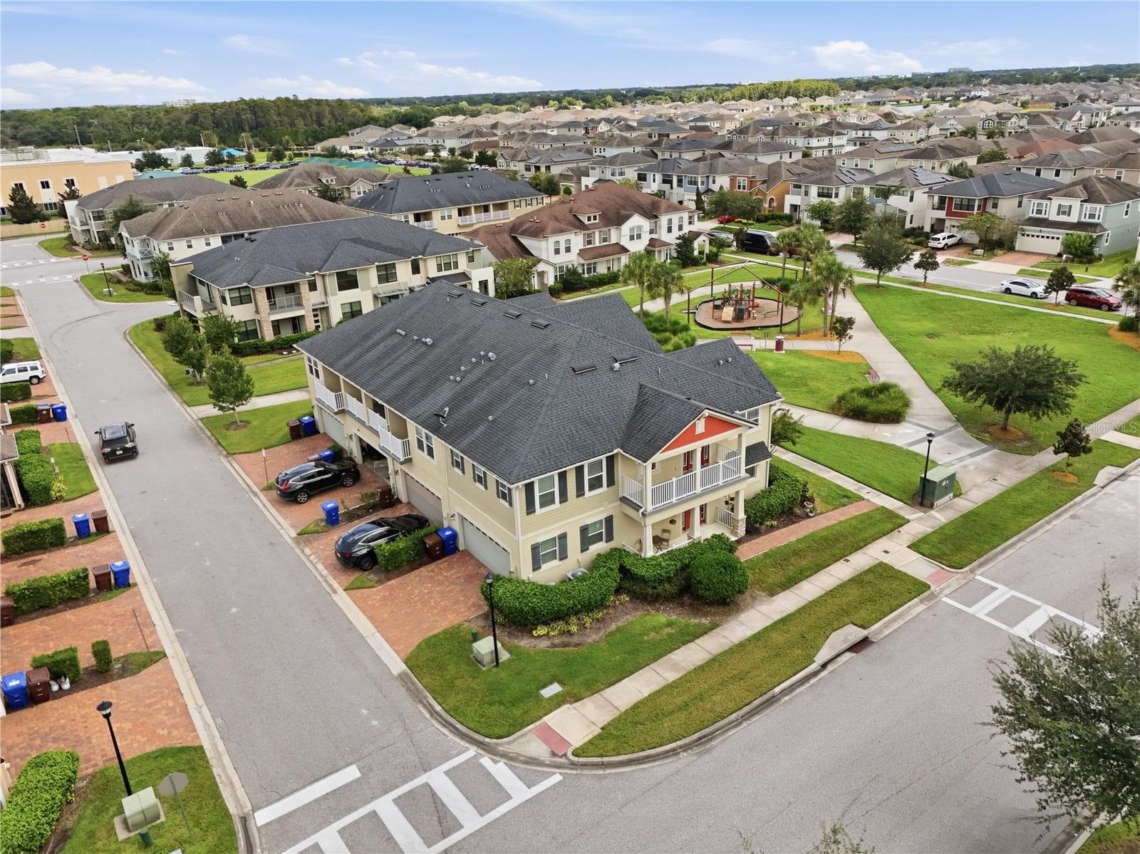 Aerial view showcasing the end-unit townhome directly beside the community park and playground. - 2615 GIARDINO LOOP, KISSIMMEE