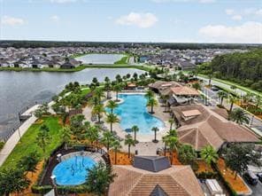 Aerial view of Tapestry’s resort-style pool complex surrounded by scenic community lakes. - 2615 GIARDINO LOOP, KISSIMMEE