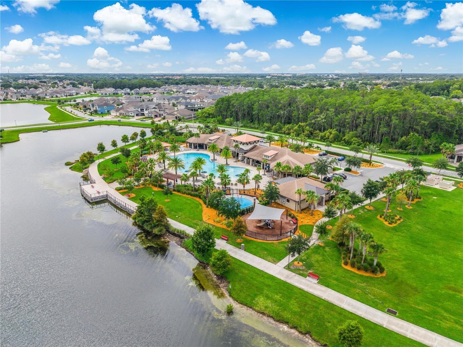 Aerial view of Tapestry’s lakefront amenity center, resort-style pool and scenic walking trails. - 2615 GIARDINO LOOP, KISSIMMEE