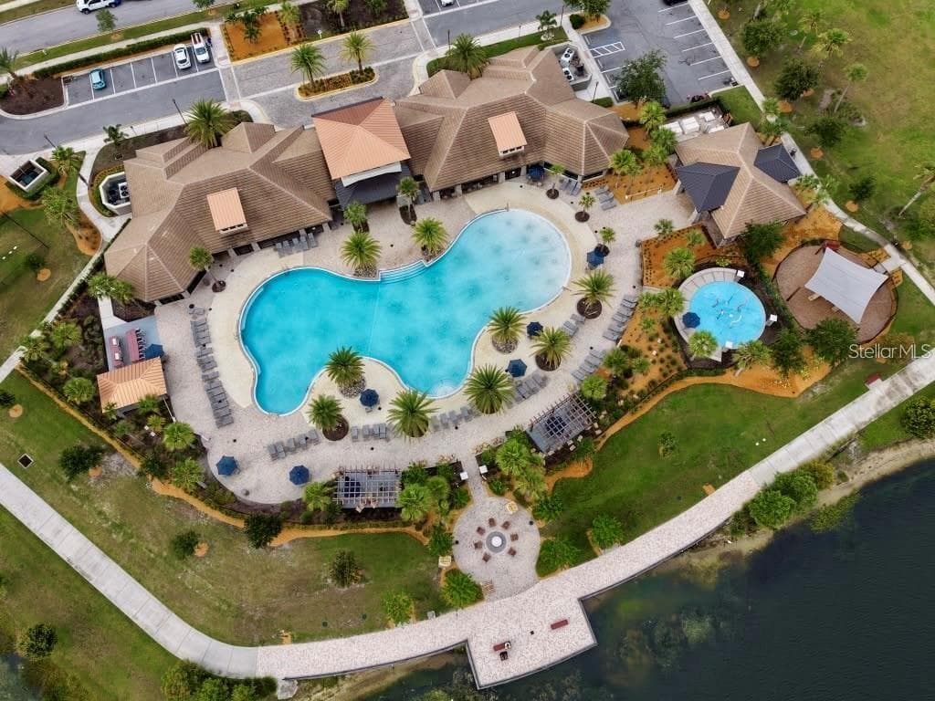 Bird’s-eye view of Tapestry’s resort-style pool, splash pad, clubhouse and lakefront gathering areas. - 2615 GIARDINO LOOP, KISSIMMEE