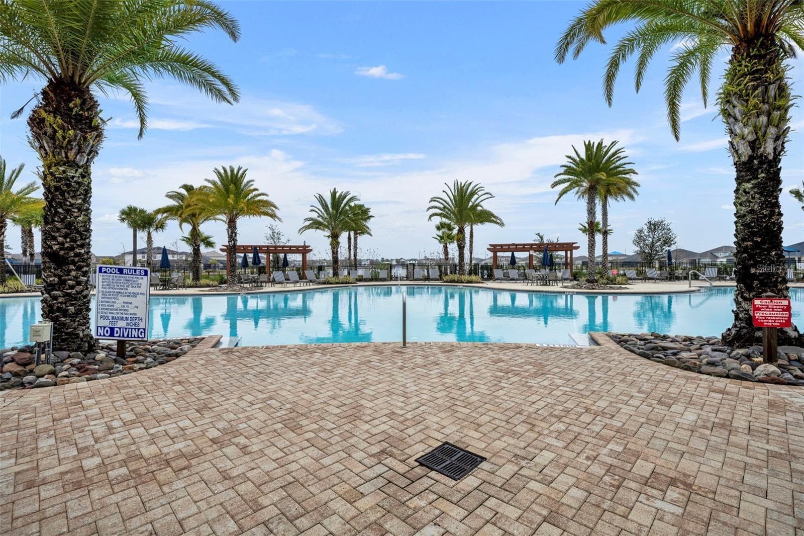 Tapestry’s resort-style community pool with abundant lounge seating and shaded cabanas. - 2615 GIARDINO LOOP, KISSIMMEE