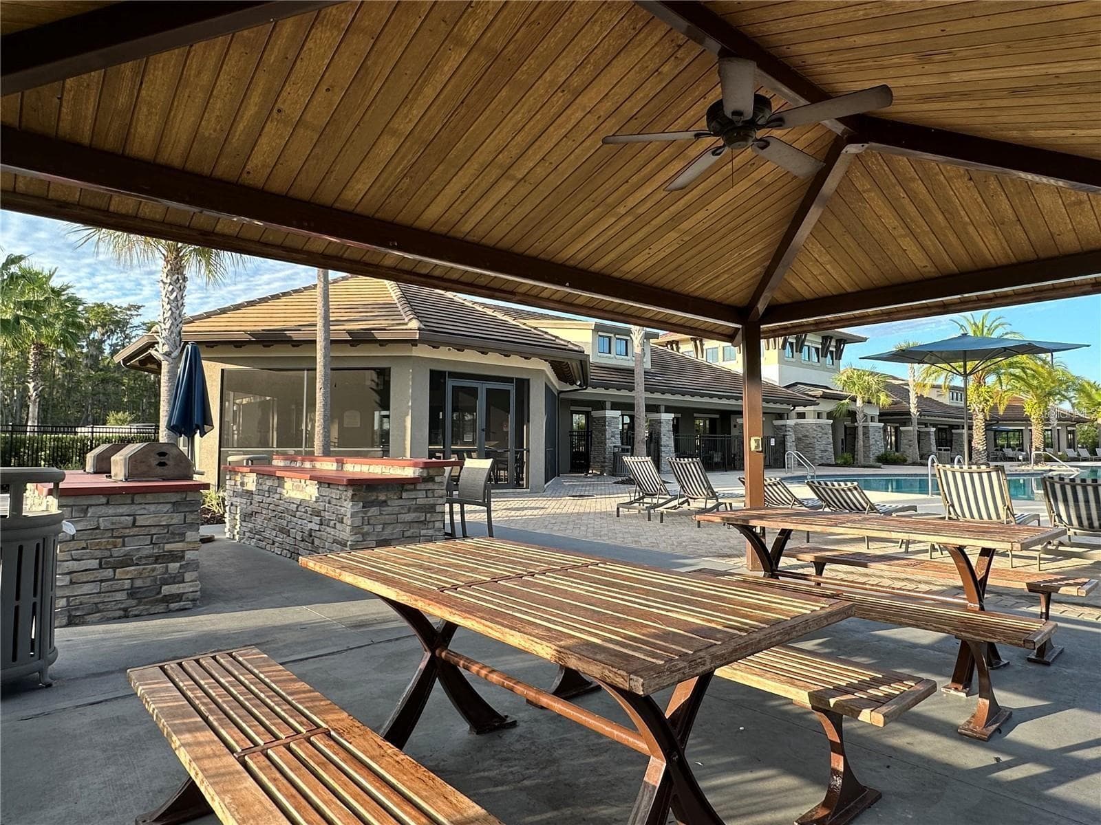 Covered poolside picnic pavilion with grilling stations—perfect for outdoor gatherings. - 2615 GIARDINO LOOP, KISSIMMEE