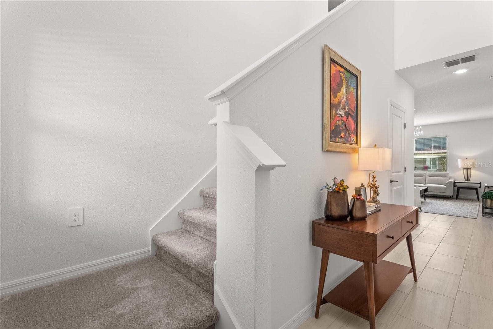 Entryway with carpeted staircase leading to the second floor. - 8431 BELLA MAR TRL, PARRISH