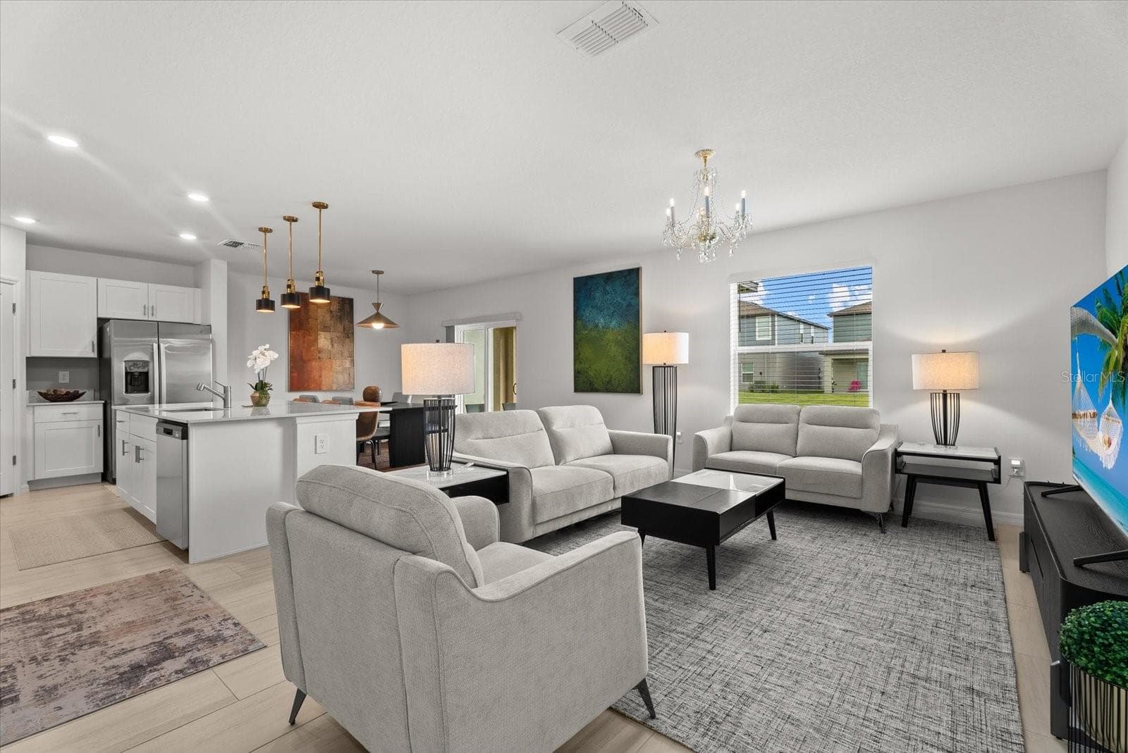 Spacious open-concept living area flowing seamlessly into the kitchen and dining space. - 8431 BELLA MAR TRL, PARRISH
