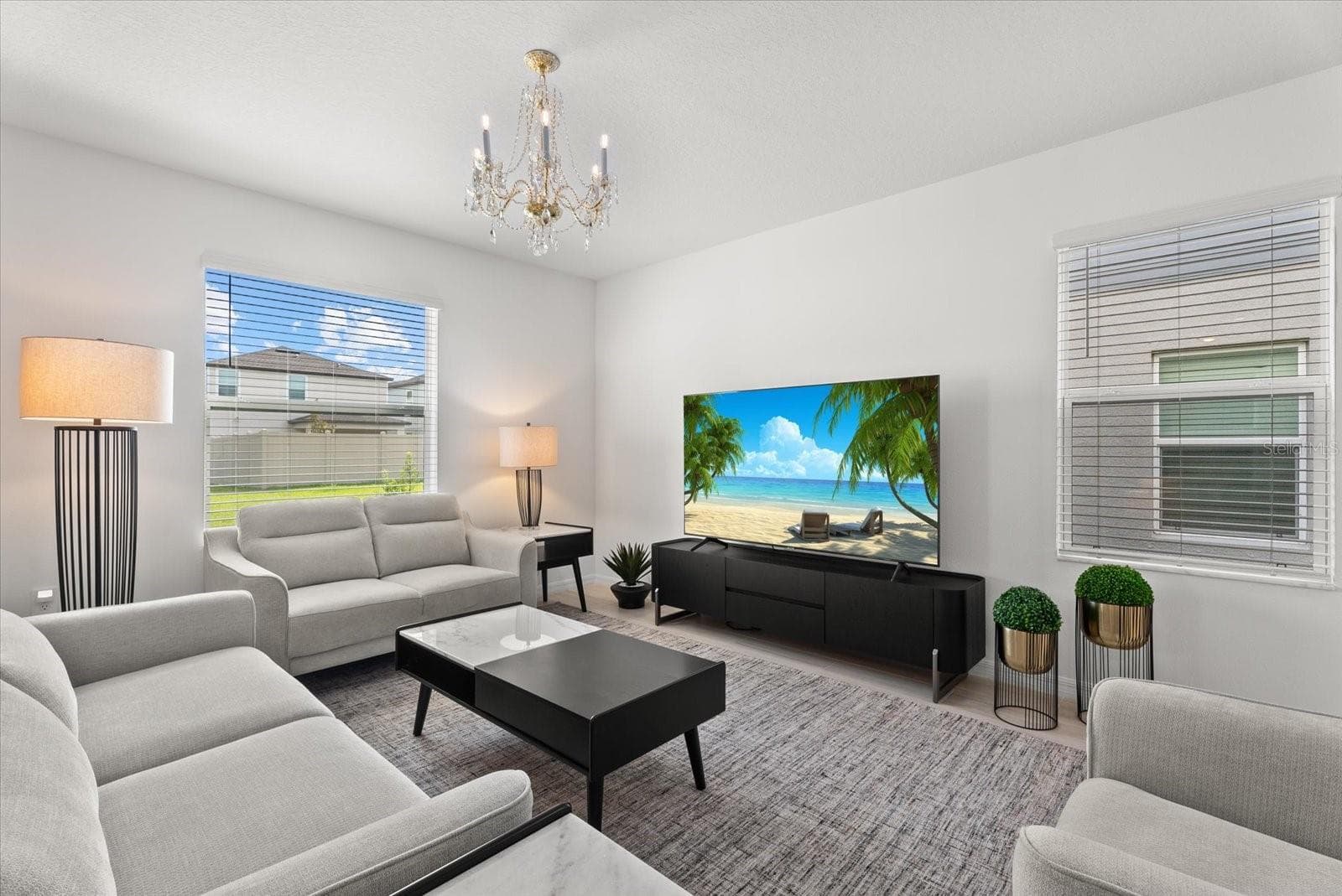 Bright living room with multiple windows and plenty of space for entertaining. - 8431 BELLA MAR TRL, PARRISH
