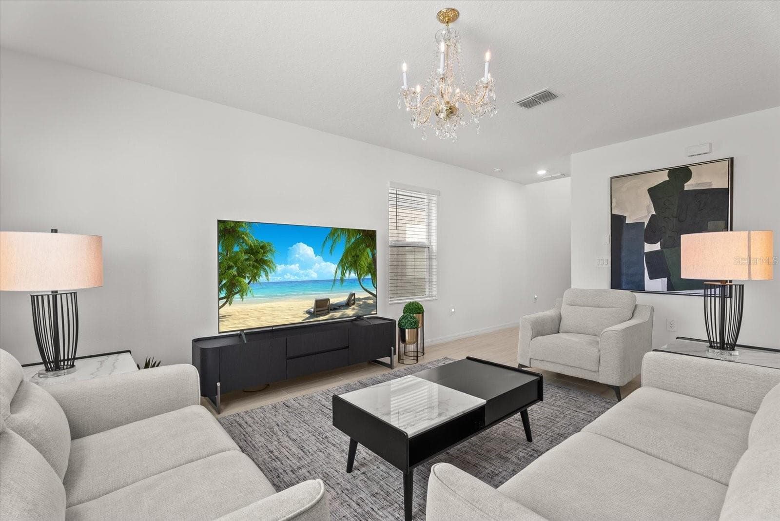 Comfortable living area featuring neutral finishes and a decorative chandelier. - 8431 BELLA MAR TRL, PARRISH
