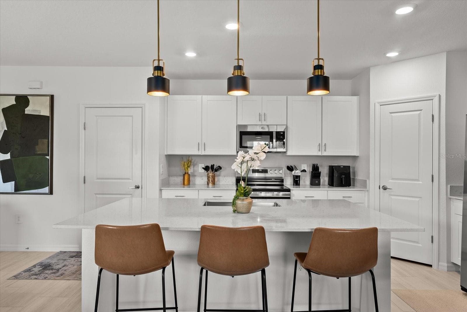 Expansive kitchen island offering generous preparation space and casual seating. - 8431 BELLA MAR TRL, PARRISH