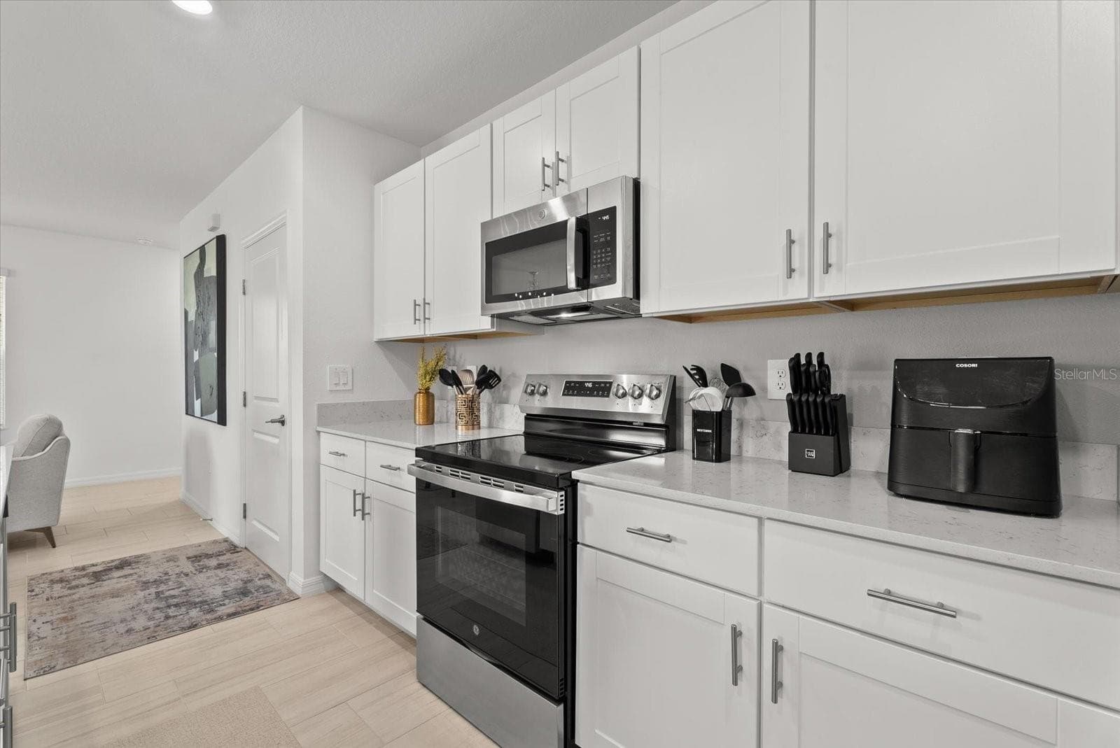 Well-appointed kitchen with abundant cabinet and countertop space. - 8431 BELLA MAR TRL, PARRISH