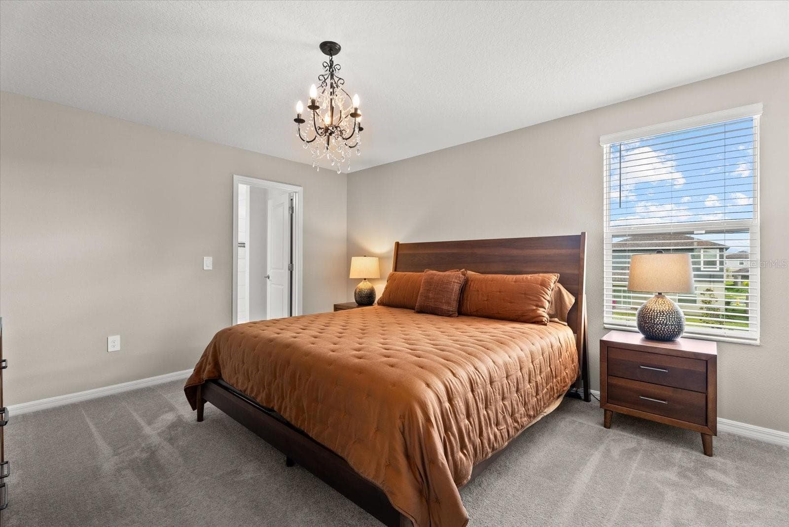 Generously sized primary bedroom with natural light and private bathroom access. - 8431 BELLA MAR TRL, PARRISH