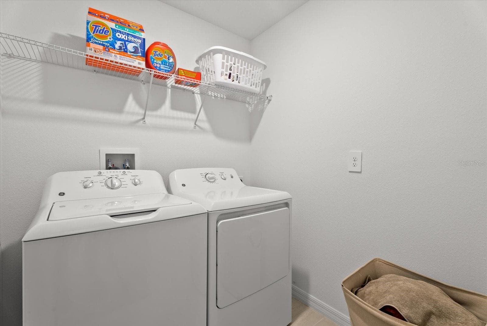 Convenient upstairs laundry room with washer, dryer, and storage shelf. - 8431 BELLA MAR TRL, PARRISH