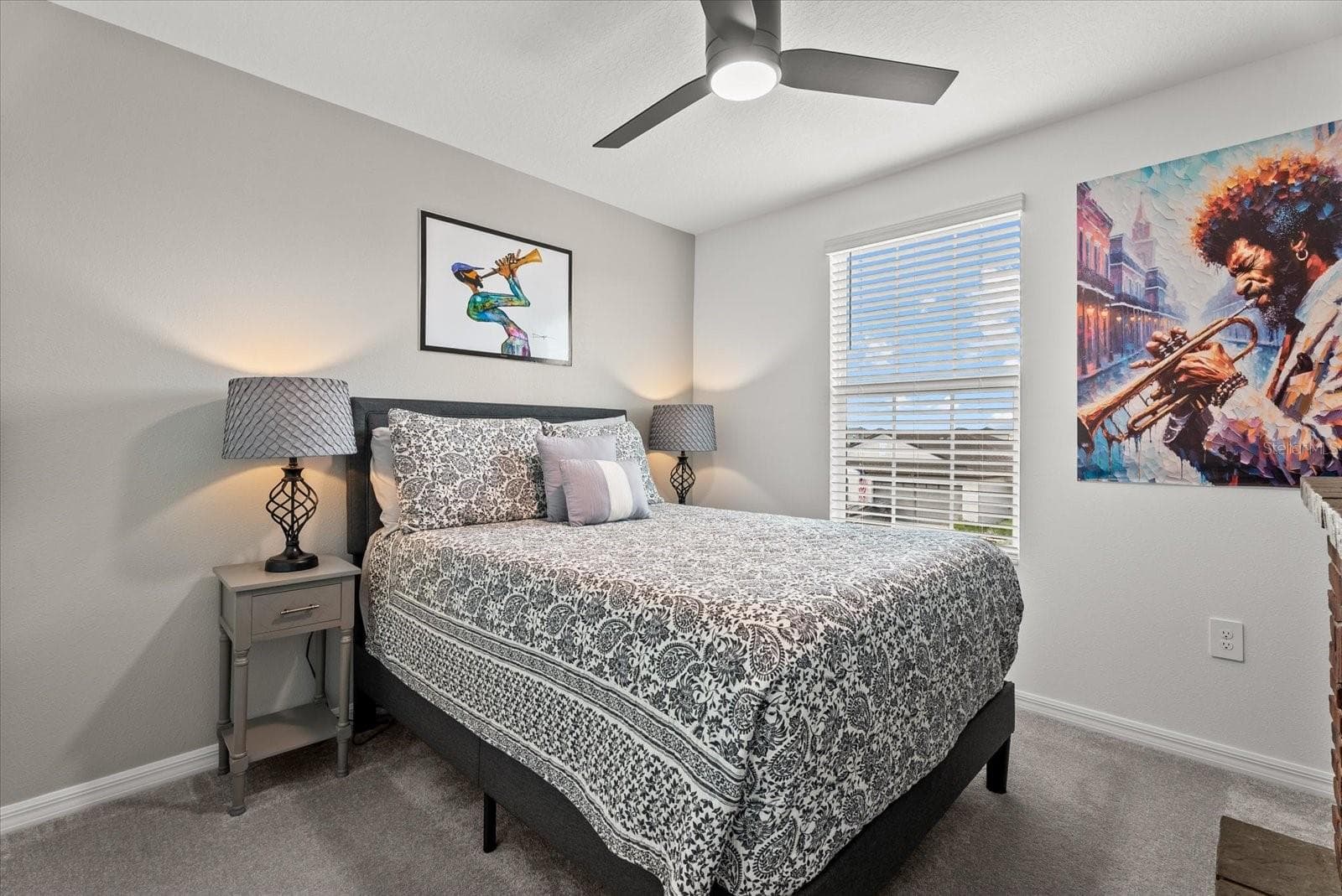 Bright secondary bedroom with ceiling fan, closet, and natural light. - 8431 BELLA MAR TRL, PARRISH