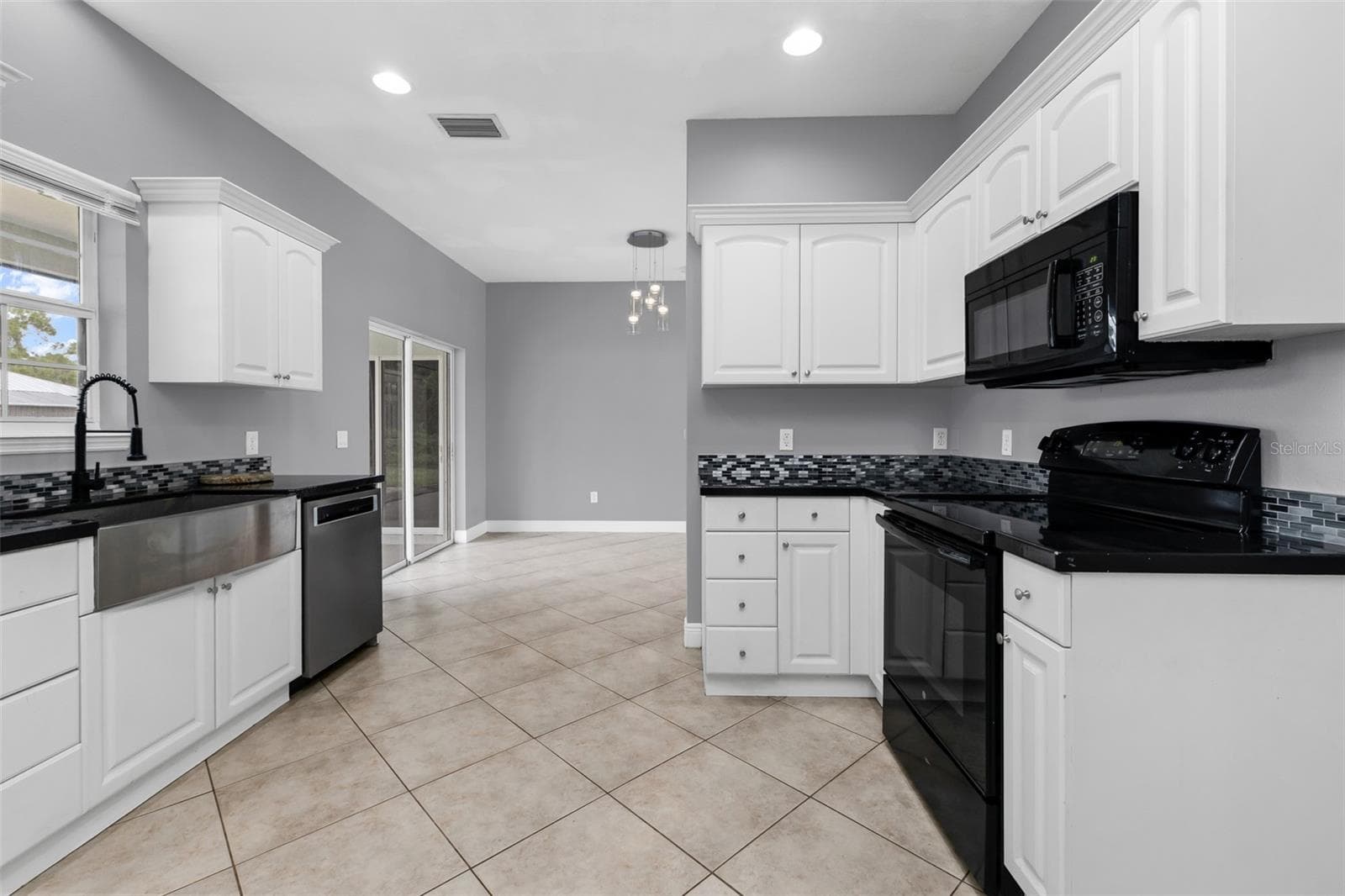 Kitchen features stainless steel farmers sink. - 2739 ATWATER DR, NORTH PORT