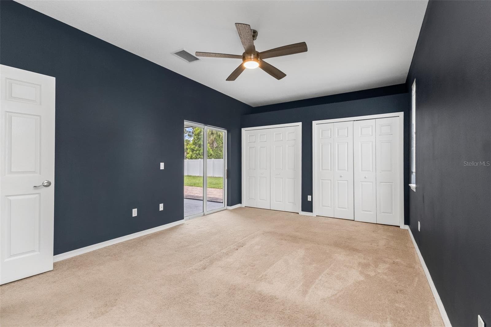 Primary bedroom dual closets and sliding glass doors to lanai. - 2739 ATWATER DR, NORTH PORT