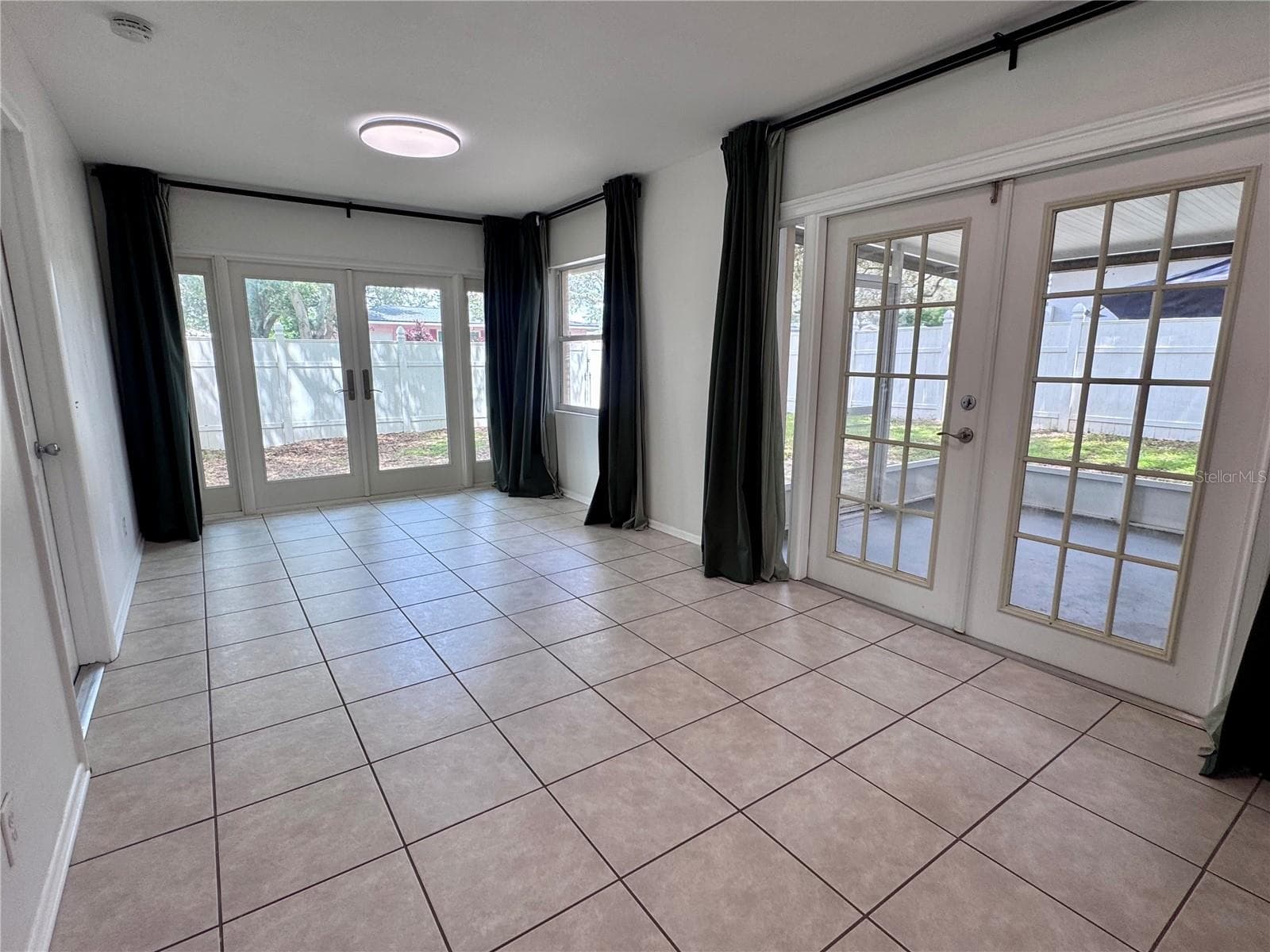 Seperate dining area with two sets of French doors for easy access to the back yard or covered patio - 1709 EATON DR NE, CLEARWATER