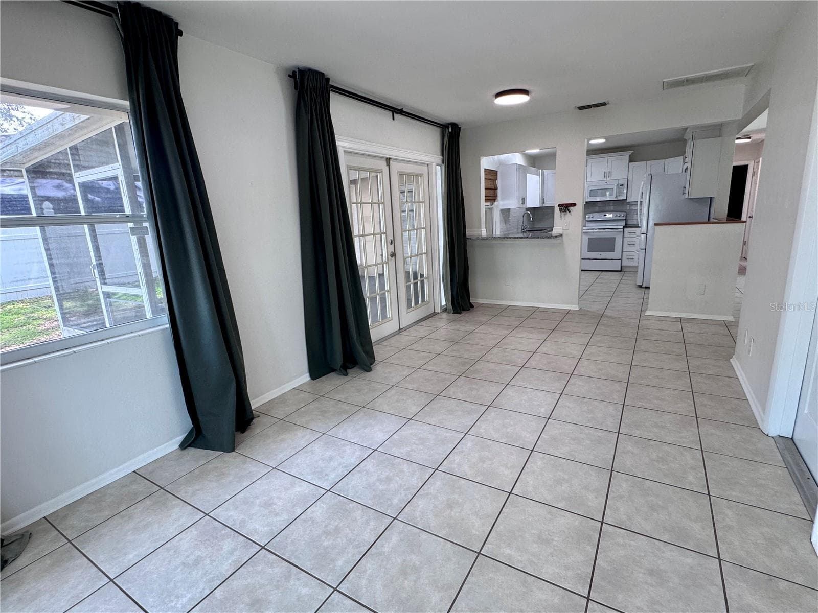 Dining room with lots of natural light - 1709 EATON DR NE, CLEARWATER