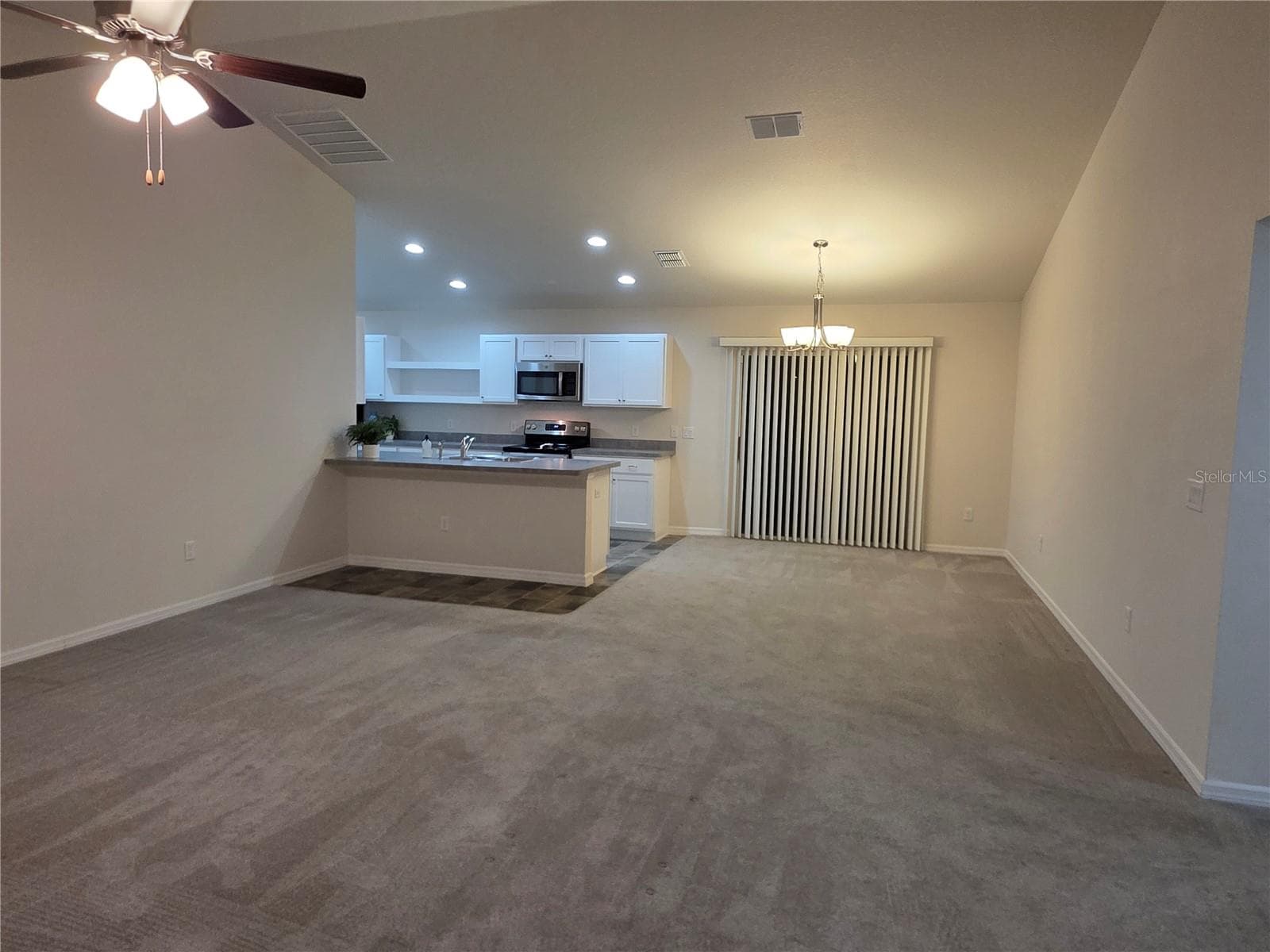 Living room into the dining area and open kitchen - 3418 SW 155TH PL, OCALA