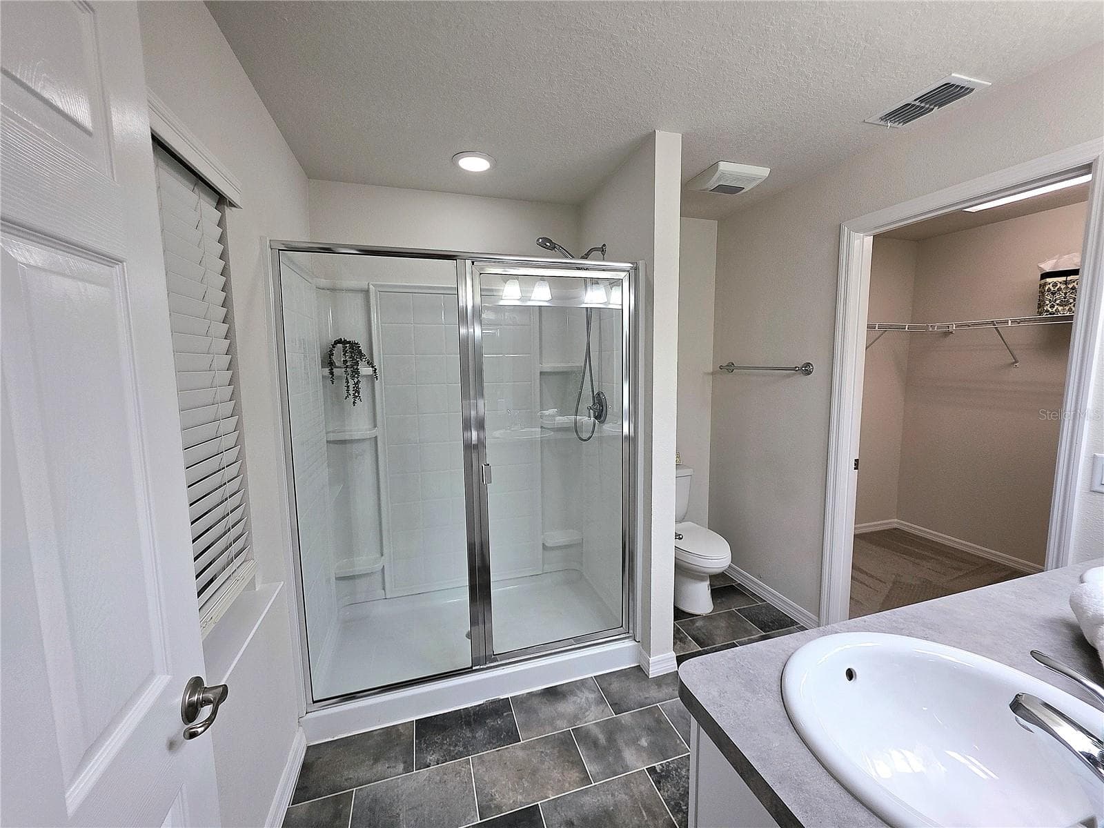 Primary bathroom showing the entranced and the glass enclosed shower area - 3418 SW 155TH PL, OCALA