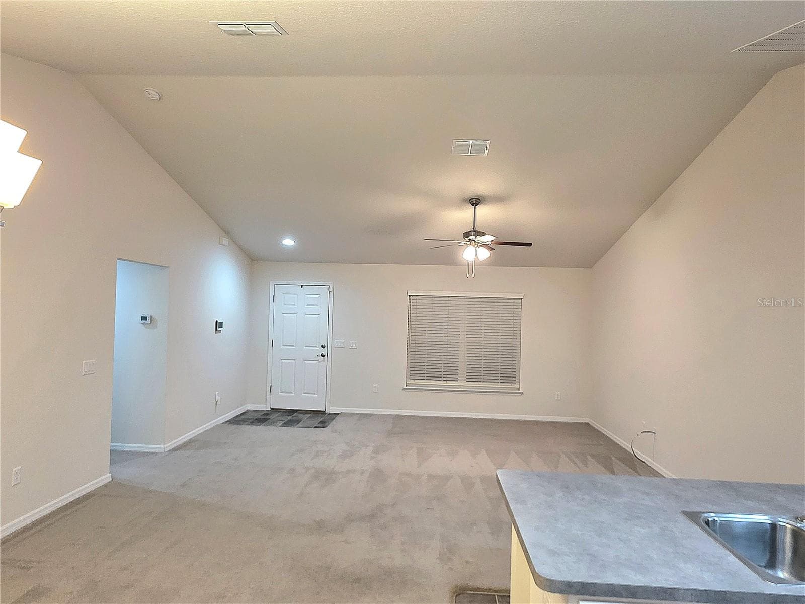 View into the living room from the kitchen area - 3418 SW 155TH PL, OCALA