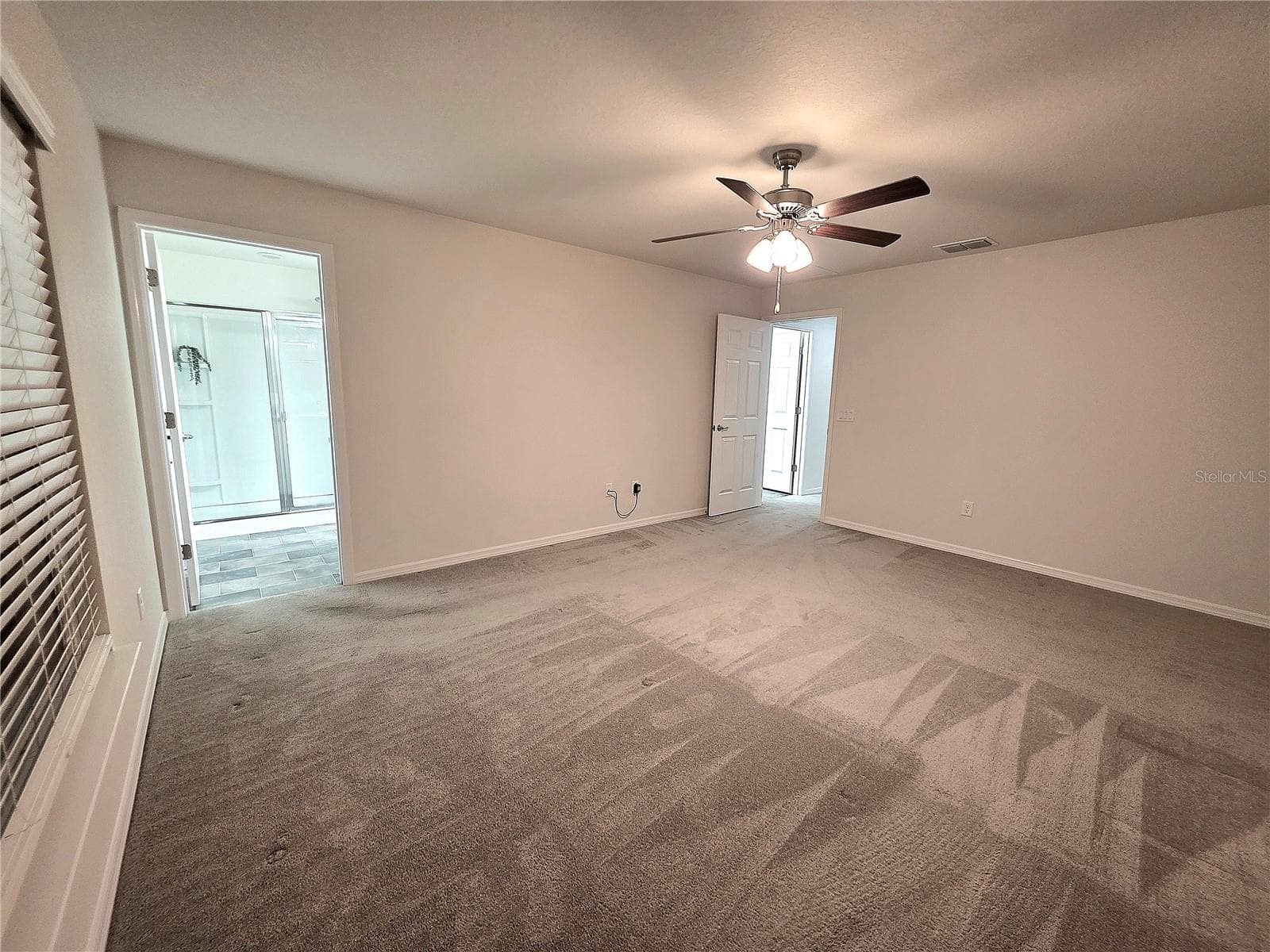 Primary bedroom showing the entrance to the hall and the bathroom - 3418 SW 155TH PL, OCALA