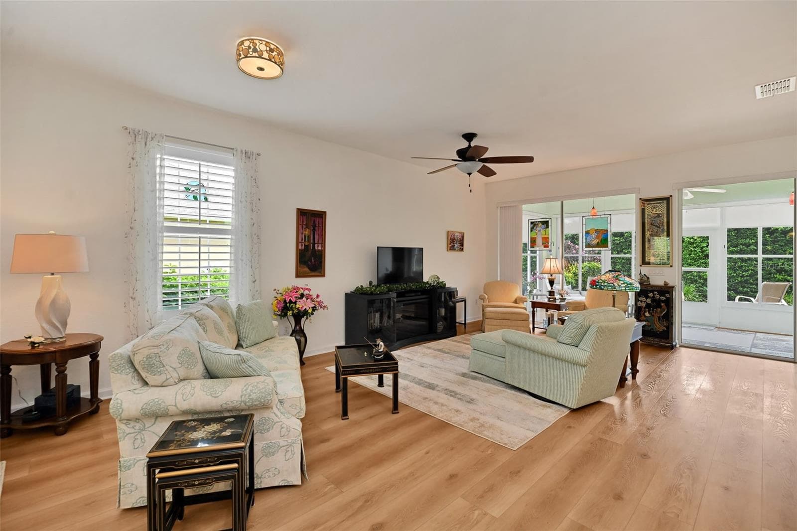 Open concept Living/Dining Areas with luxury vinyl plank flooring and included fireplace console. - 7139 SW 91ST CT, OCALA