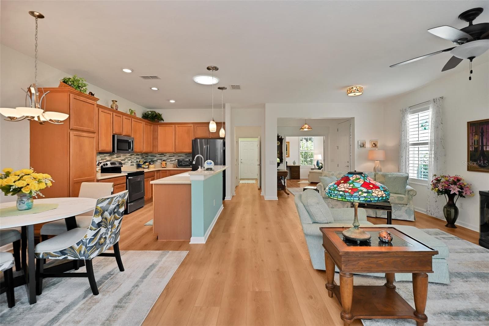 Open concept Living/Dining/Kitchen Areas with luxury vinyl plank flooring. - 7139 SW 91ST CT, OCALA