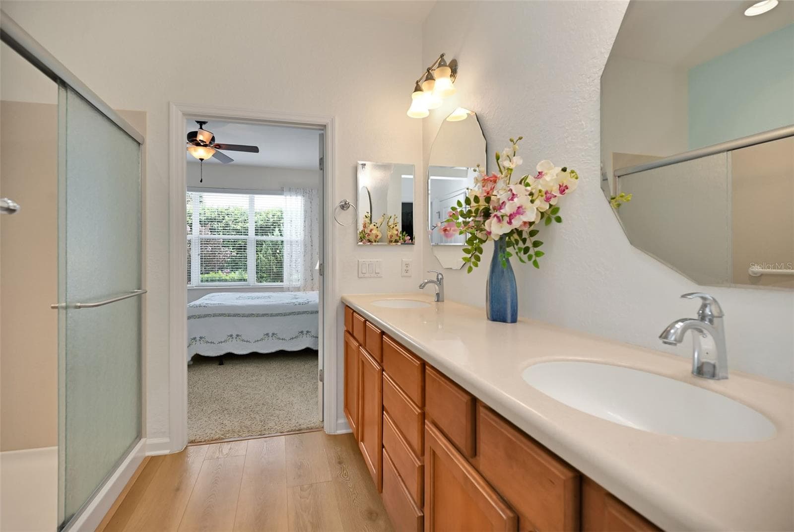 Primary ensuite bath with double vanity, walk-in shower, private commode, linen closet & walk-in closet - 7139 SW 91ST CT, OCALA