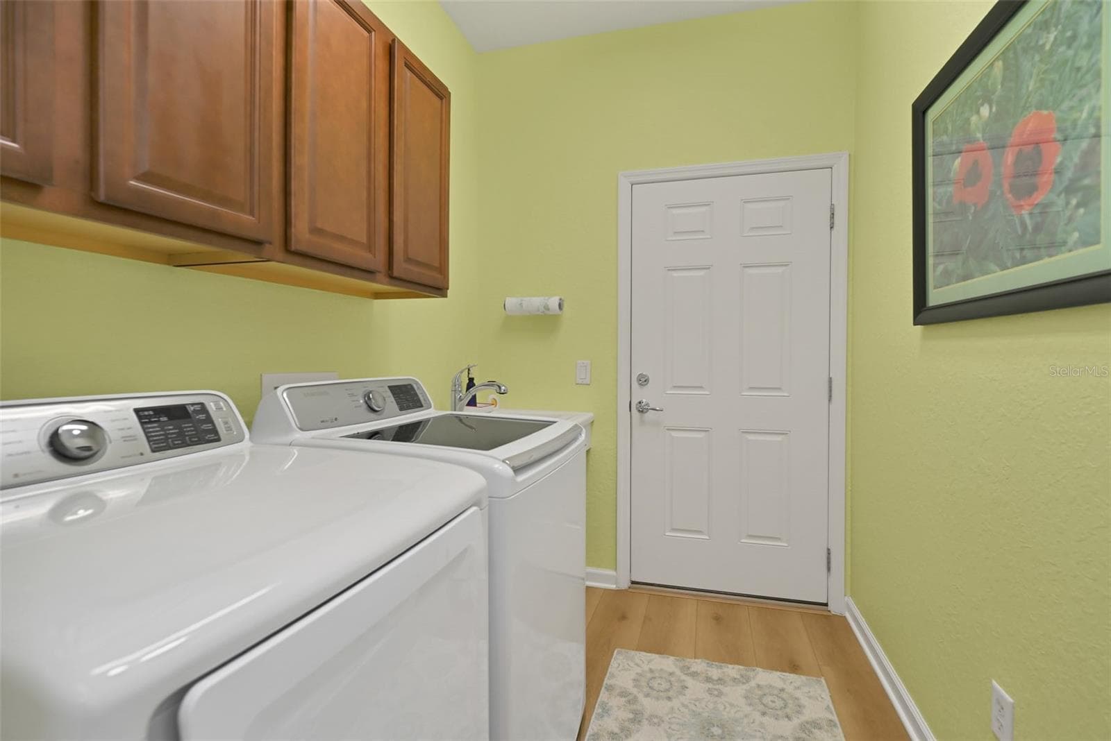 Laundry room with washer, dryer, cabinets, and utility sink - 7139 SW 91ST CT, OCALA