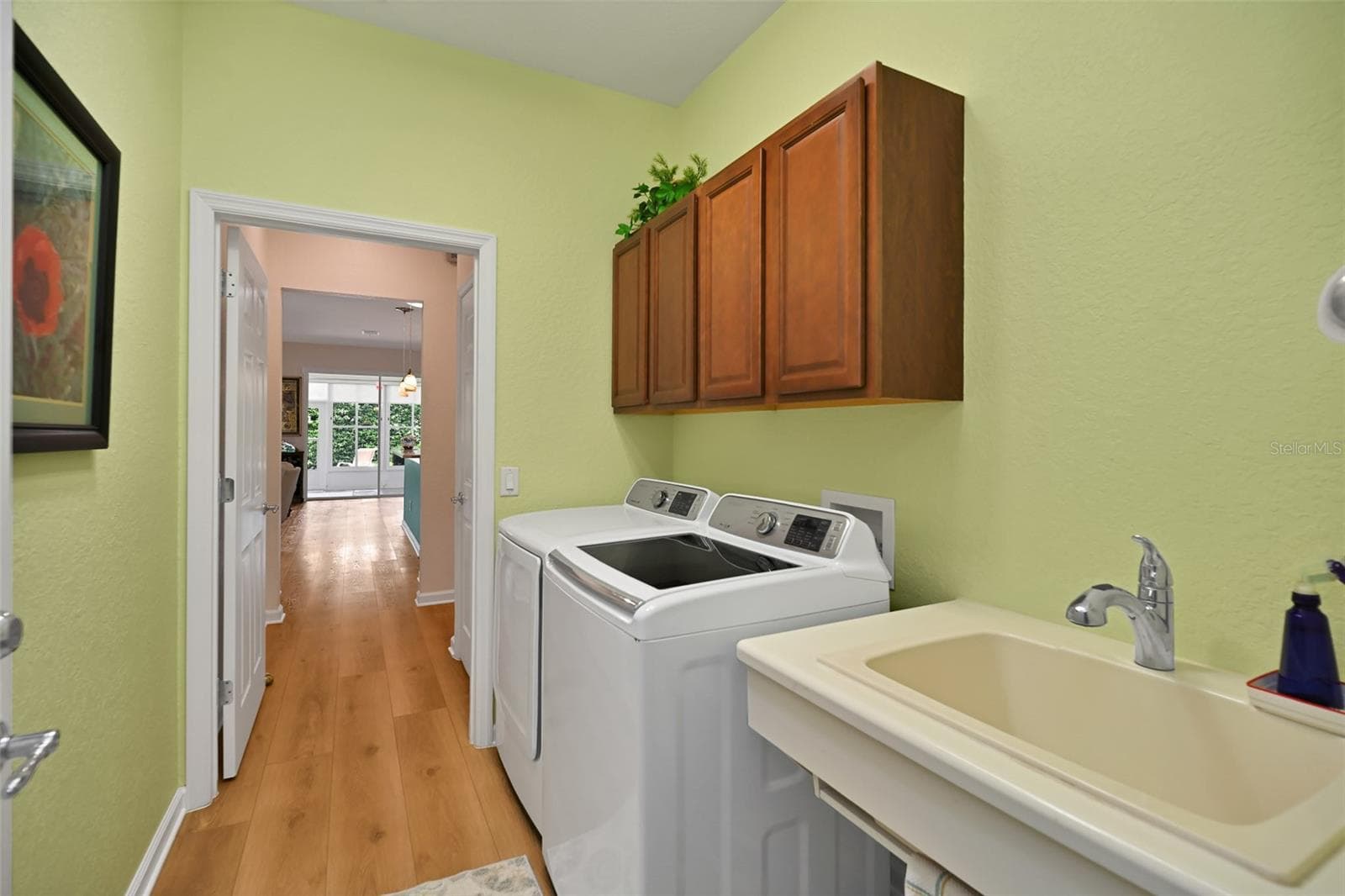 Laundry room with washer, dryer, cabinets, and utility sink - 7139 SW 91ST CT, OCALA