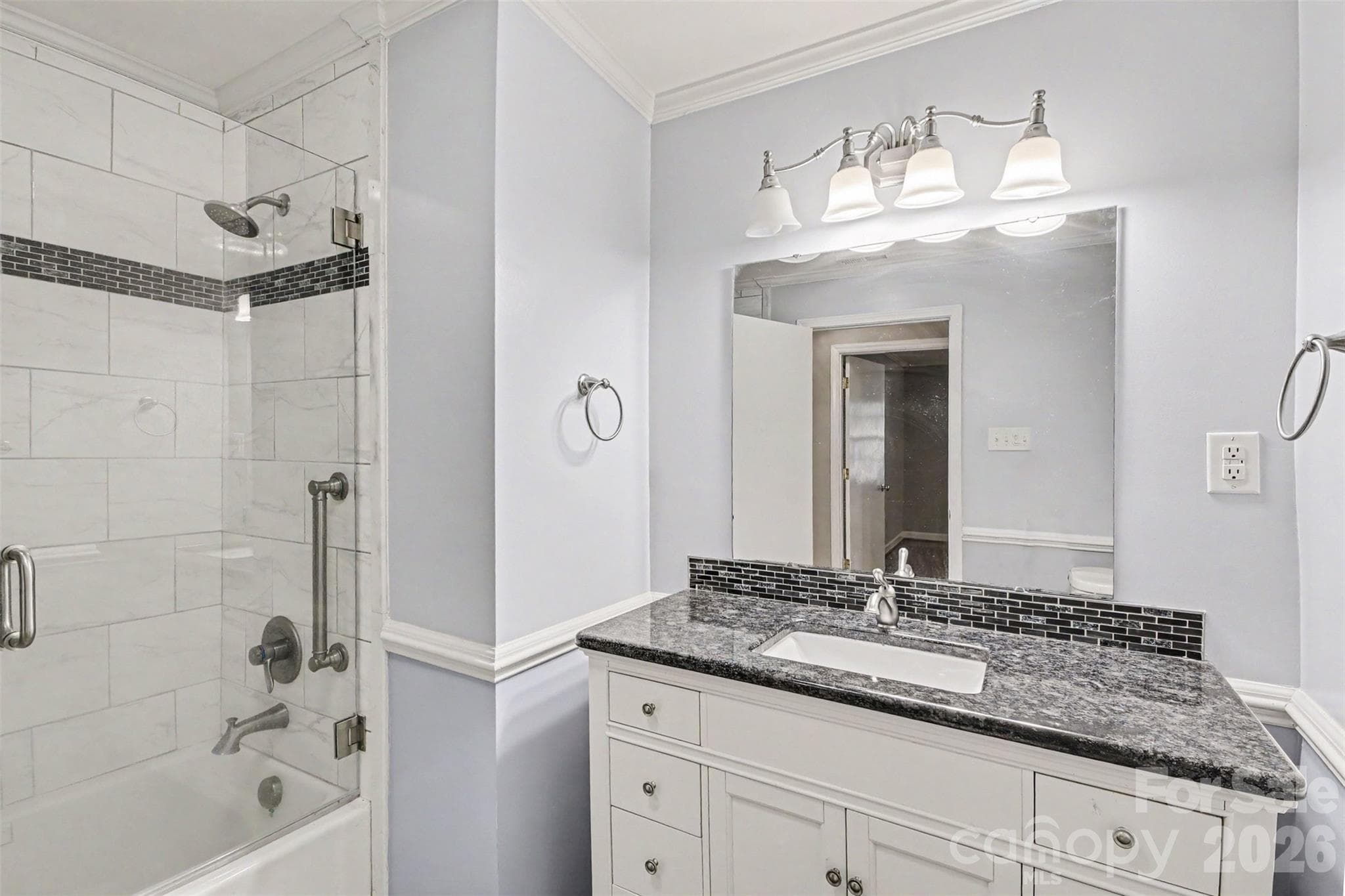 The Updated Hall bath boast a tiled Tub/Shower Combo, Tile Flooring, and Large Granite Vanity - 113 Brookshire Avenue, Kannapolis