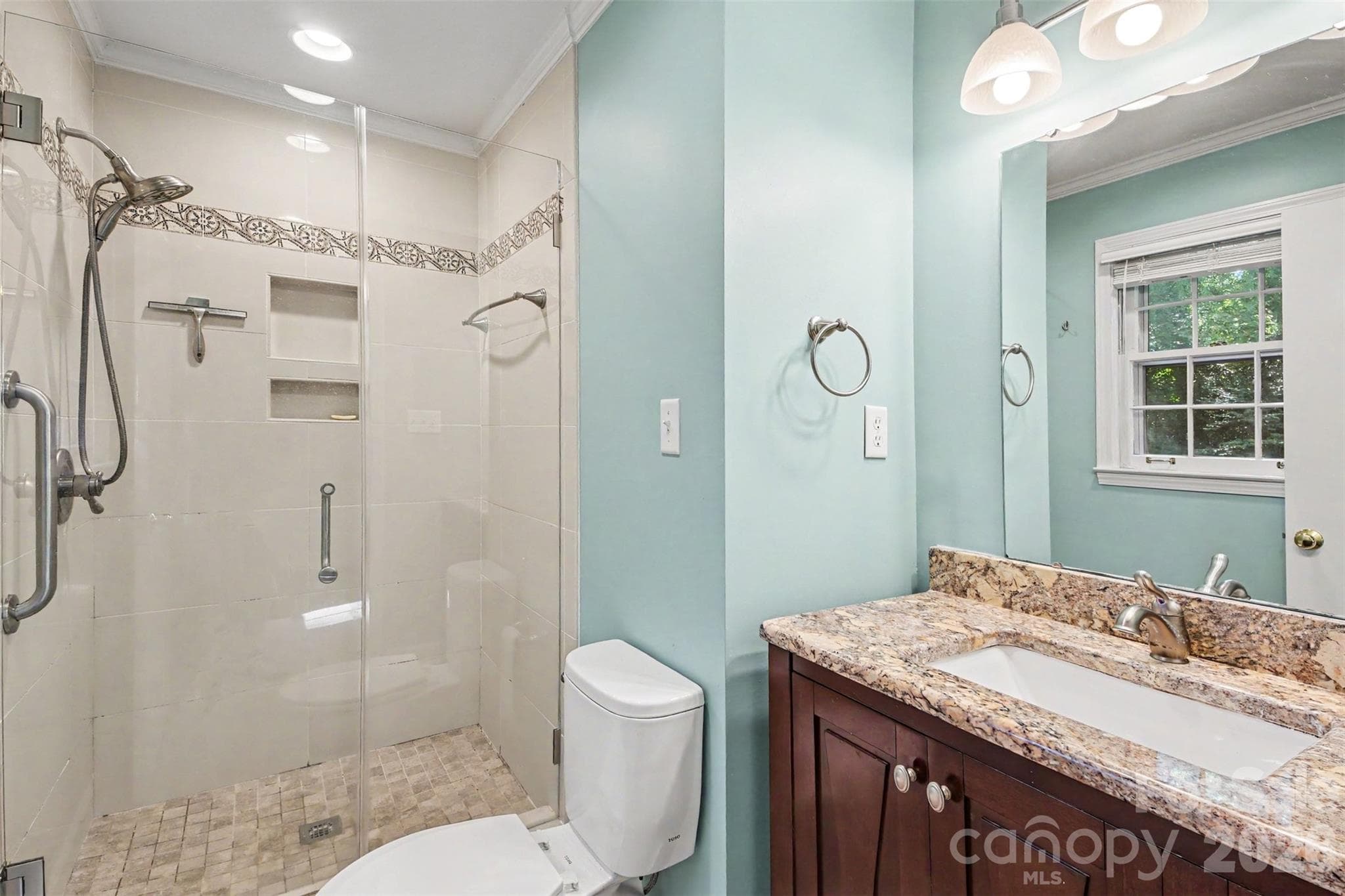 The Updated Primary Full Sized bath features a tiled walk-in shower and Vanity - 113 Brookshire Avenue, Kannapolis