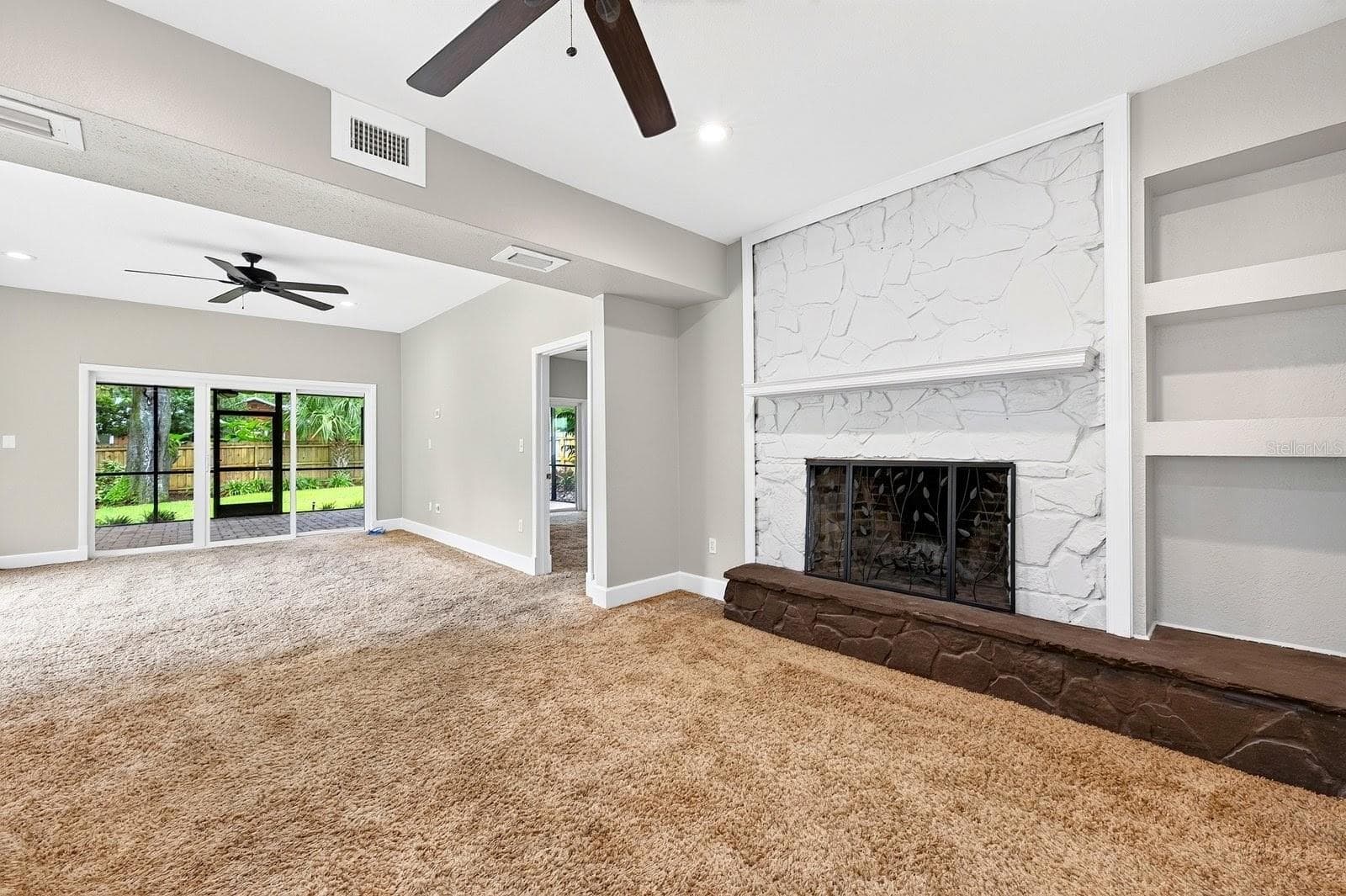 The first area of the family room features a fireplace feature wall. - 1212 ELMWOOD ST, ORLANDO