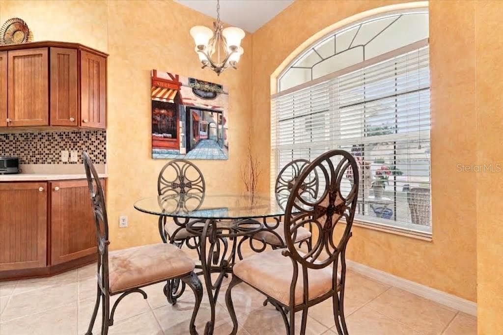 table on kitchen, virtual staged - 438 TROY LOOP, THE VILLAGES