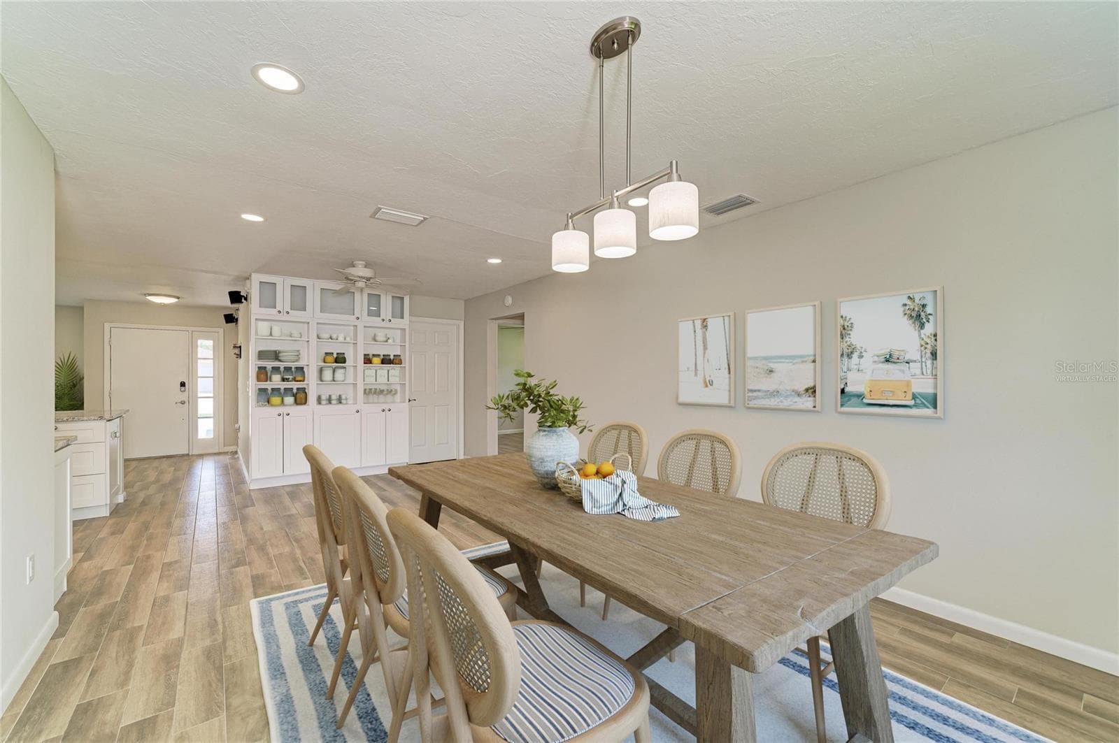 Virtually staged. Large dining room off the kitchen with built-in shelves and cabinets. - 2011 37TH ST W, BRADENTON