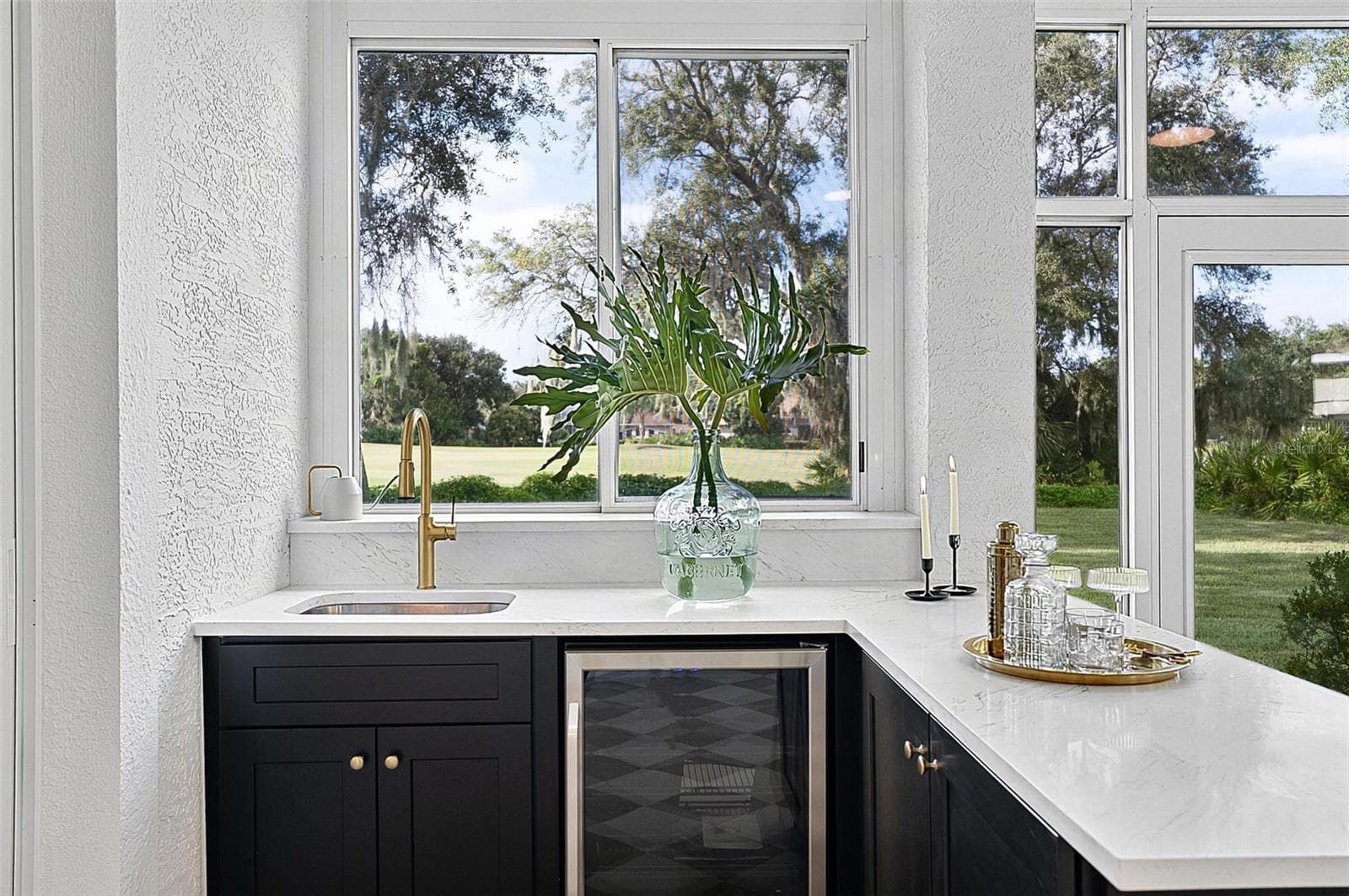 Custom wet bar with beverage refrigerator and quartz countertop in the solarium - 17 GRANDVIEW DR, PALM COAST