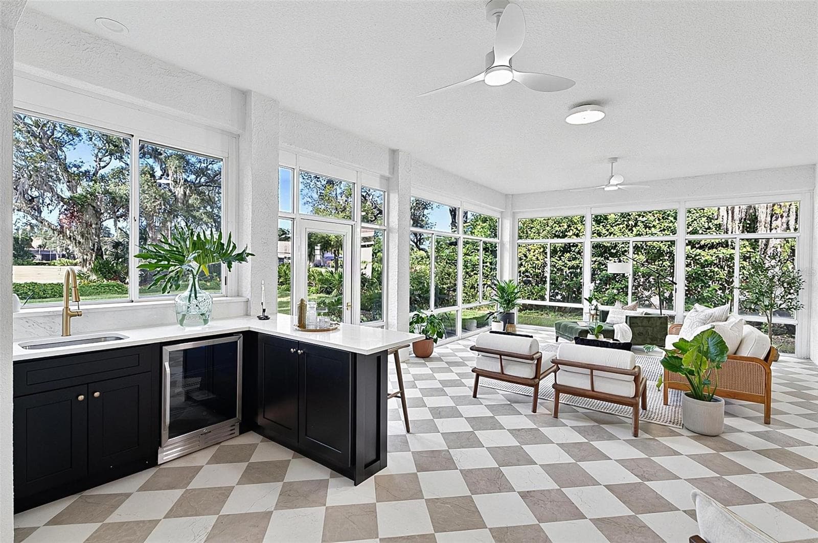 Custom wet bar with beverage refrigerator and quartz countertop in the solarium with wall to wall enclosed screen window for a view of nature at its best. Room is aired - 17 GRANDVIEW DR, PALM COAST