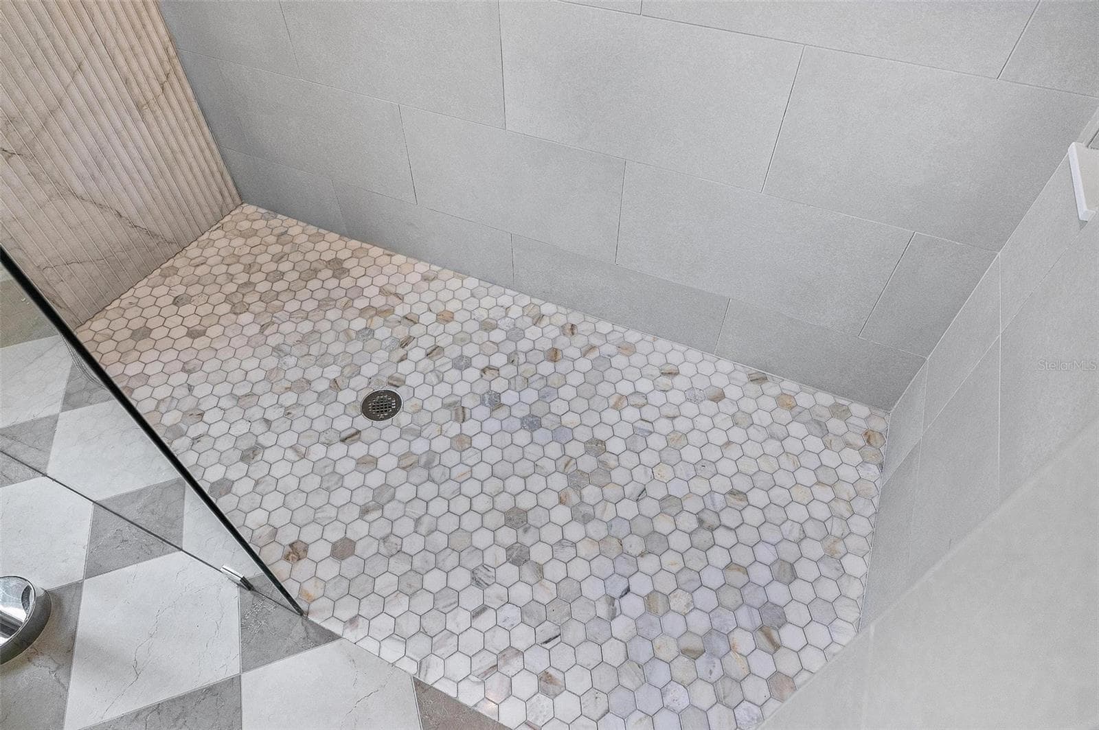 Stunning tiled shower with pebble tile floor and glass - 17 GRANDVIEW DR, PALM COAST
