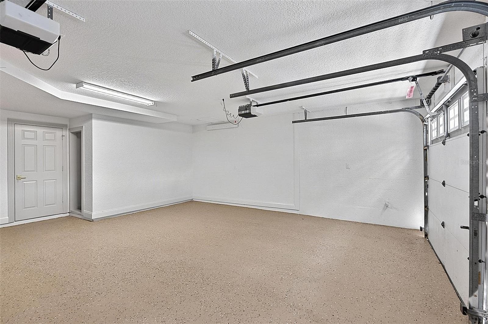Oversized double door garage with epoxy floor and extra storage area - 17 GRANDVIEW DR, PALM COAST