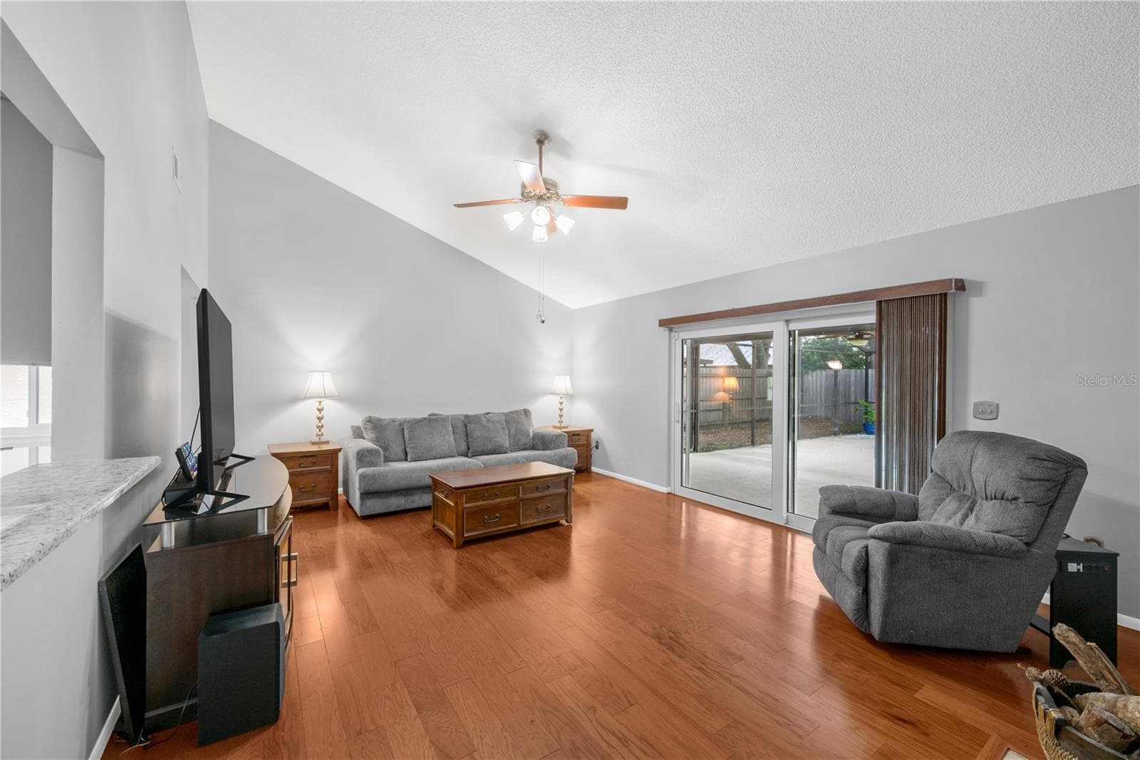 The family room has a wood burning fireplace, vaulted ceiling and easy access to the backyard pool, Spa, and patio. - 1418 SHELL FLOWER DR, BRANDON