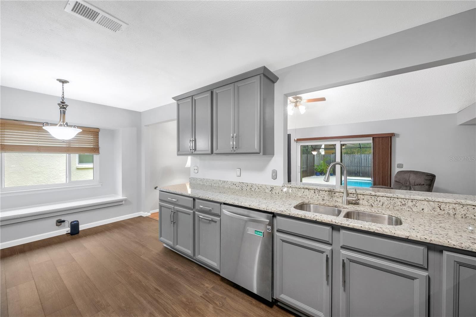 There is a pass through window and breakfast bar for seamless connection between the kitchen and family room. - 1418 SHELL FLOWER DR, BRANDON