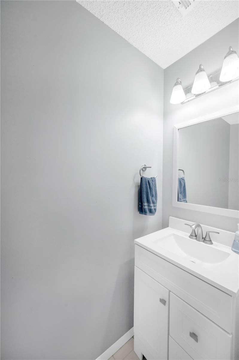 There is a convenient half bathroom on the first floor for guests. - 1418 SHELL FLOWER DR, BRANDON