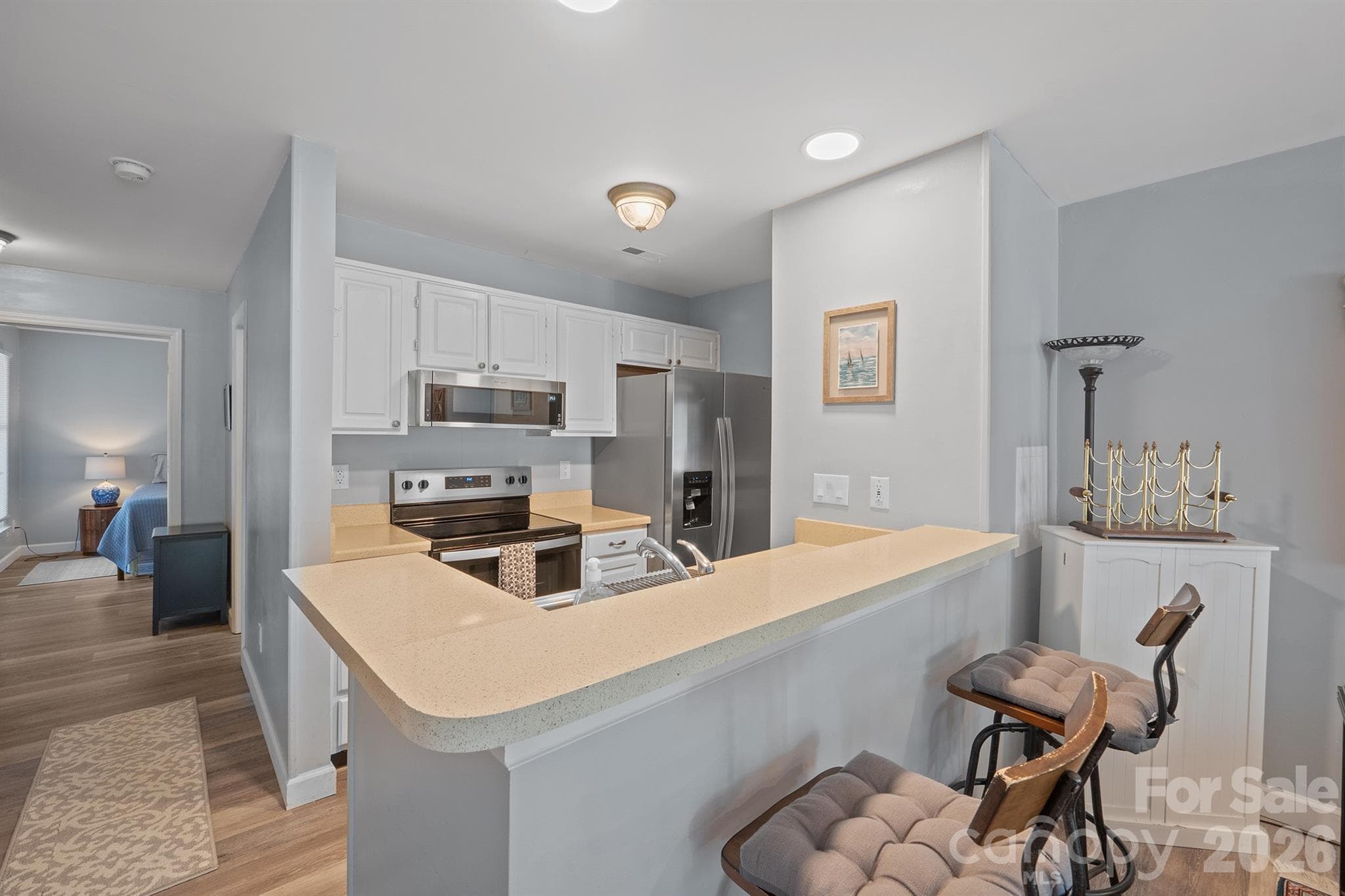 Overview of galley kitchen with stainless appliances - 327 Northwest Drive, Davidson