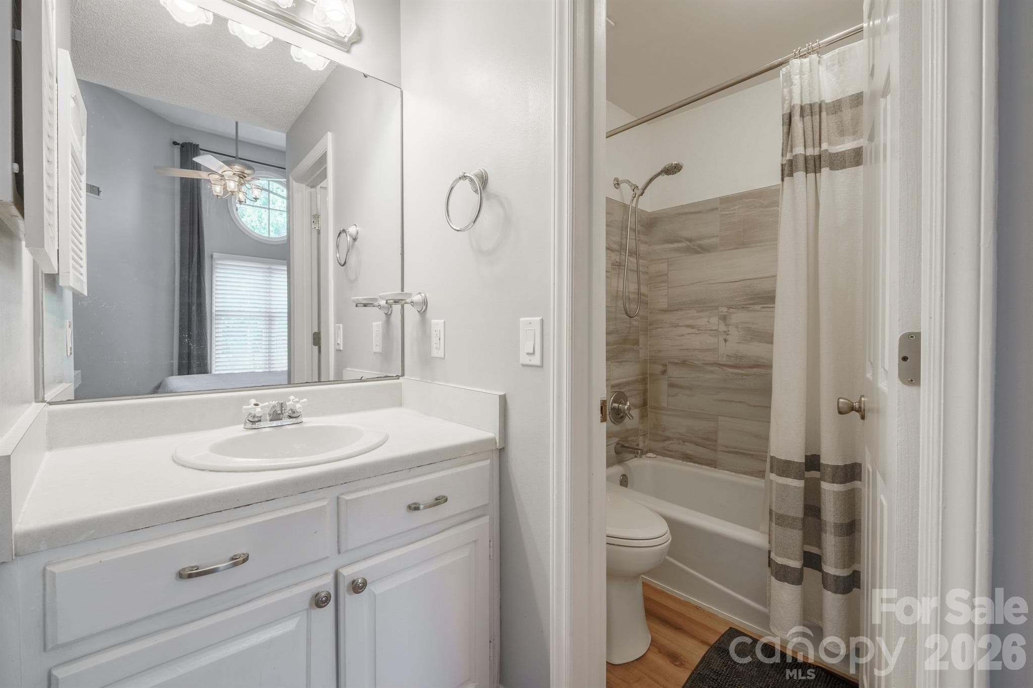 Primary bath with vanity and updated tiled shower tub combo - 327 Northwest Drive, Davidson