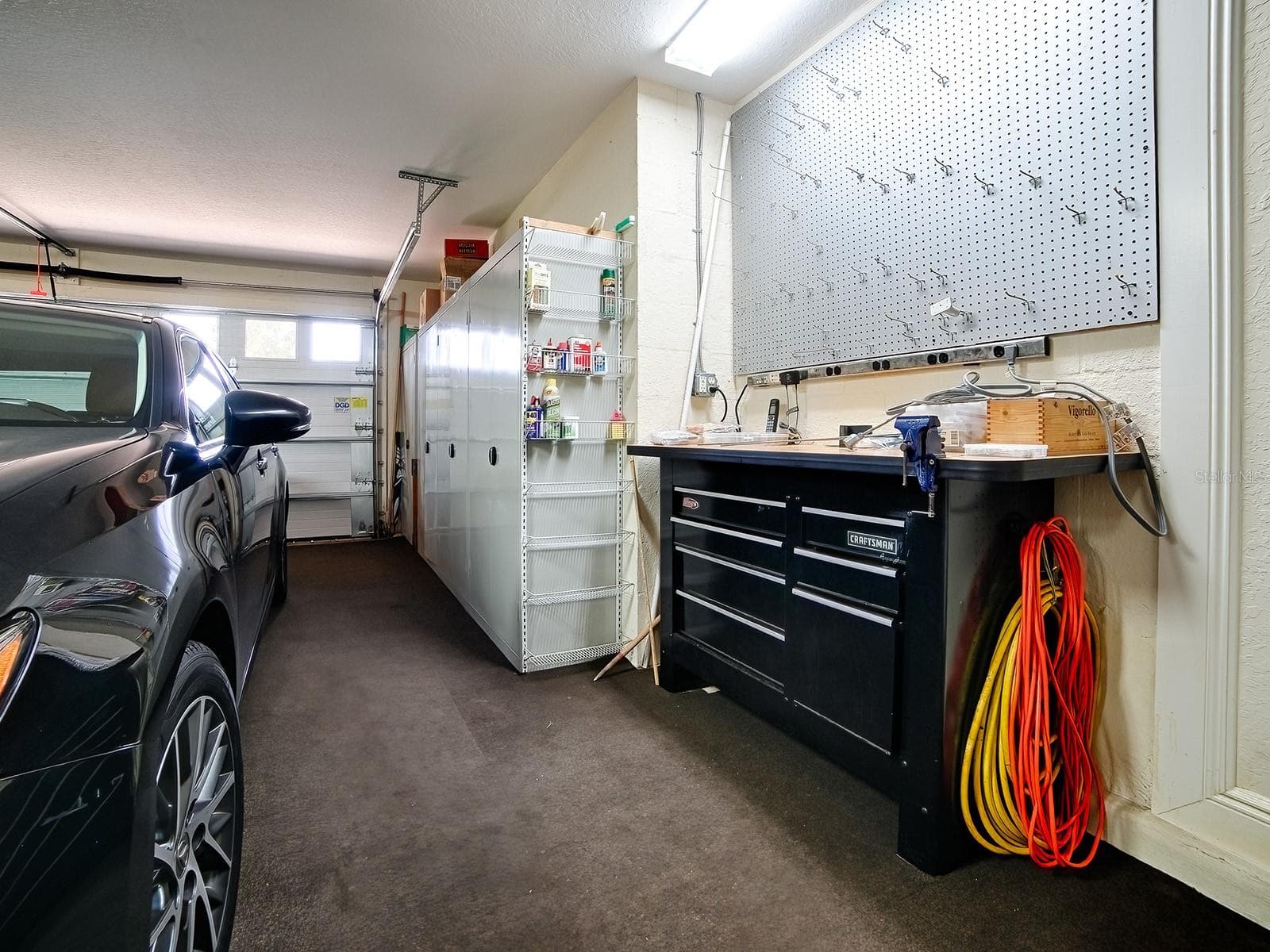 LOTS A CABINET SPACE AND INSULATED GARAGE DOORS FOR A COMFORTABLE WORK SPACE - 1089 VANCE TRL, THE VILLAGES